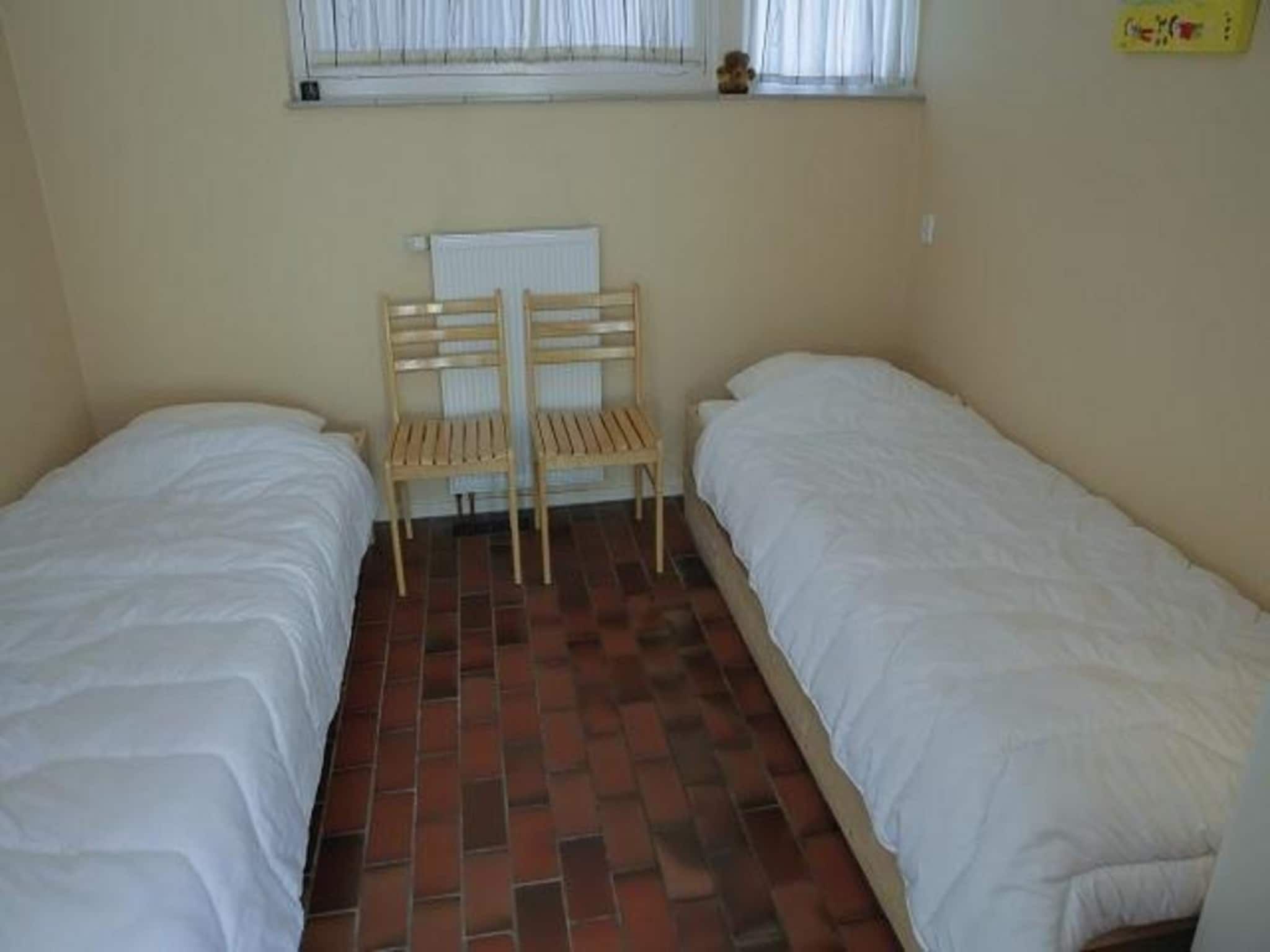 Een slaapkamer van De Schelp 14 in Sint Maartenszee