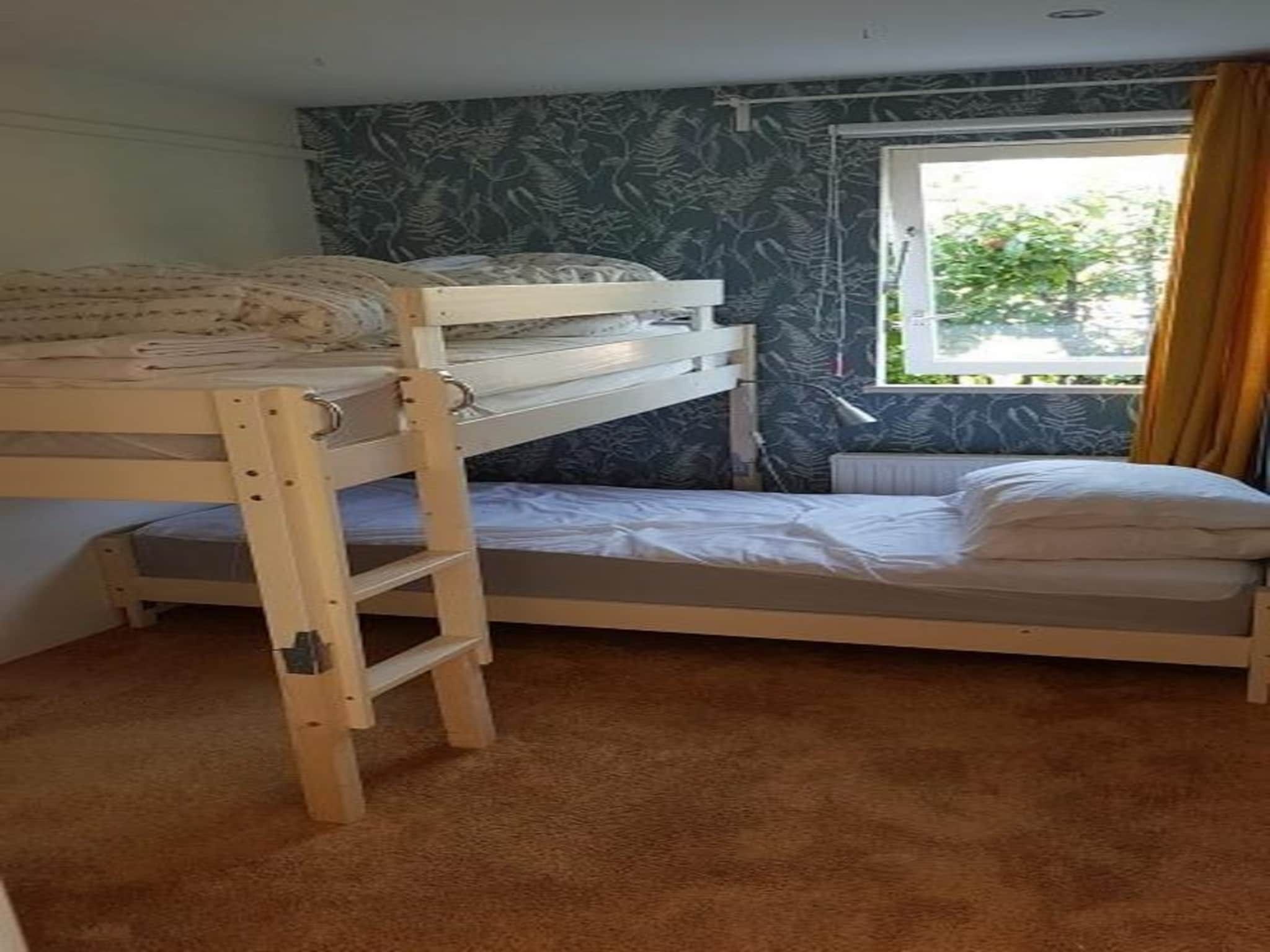 Een slaapkamer van Eb en Vloed 53 in Sint Maartenszee