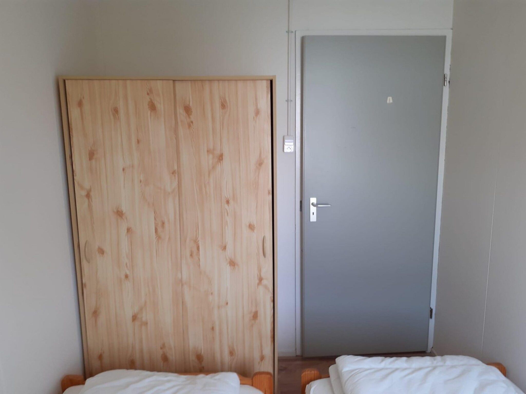 Een slaapkamer van Eb en Vloed 55 in Sint Maartenszee