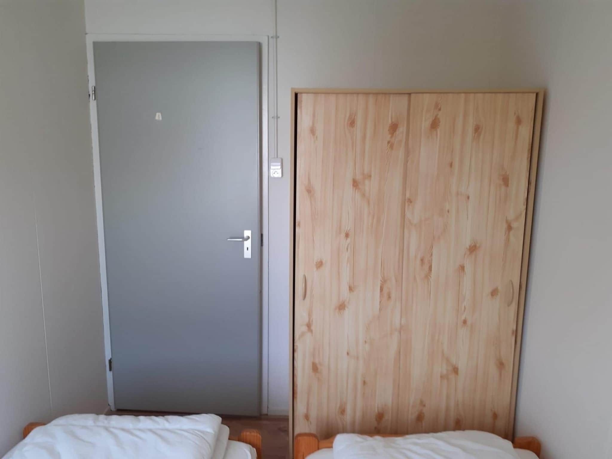 Een slaapkamer van Eb en Vloed 55 in Sint Maartenszee