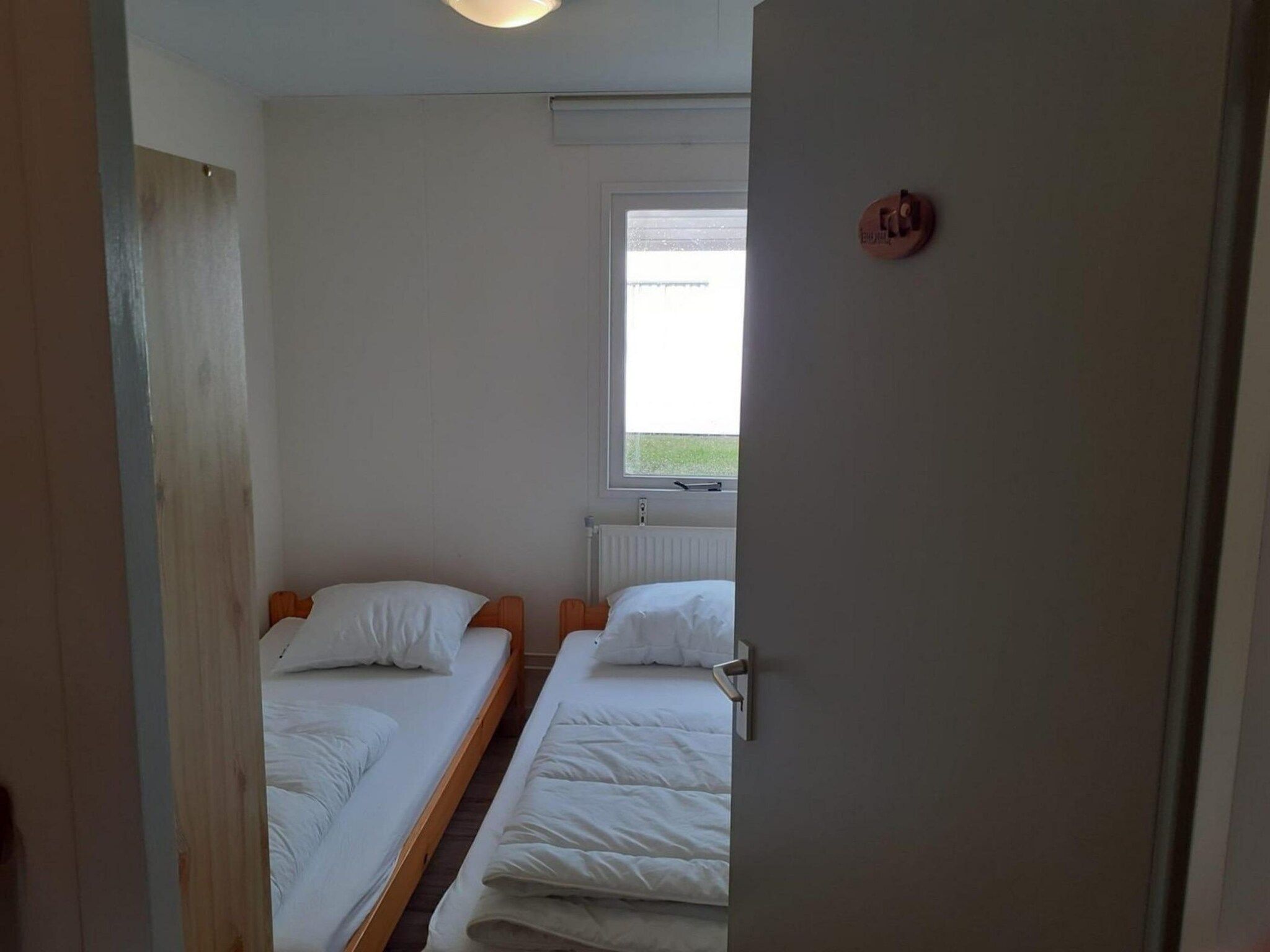 Een slaapkamer van Eb en Vloed 55 in Sint Maartenszee