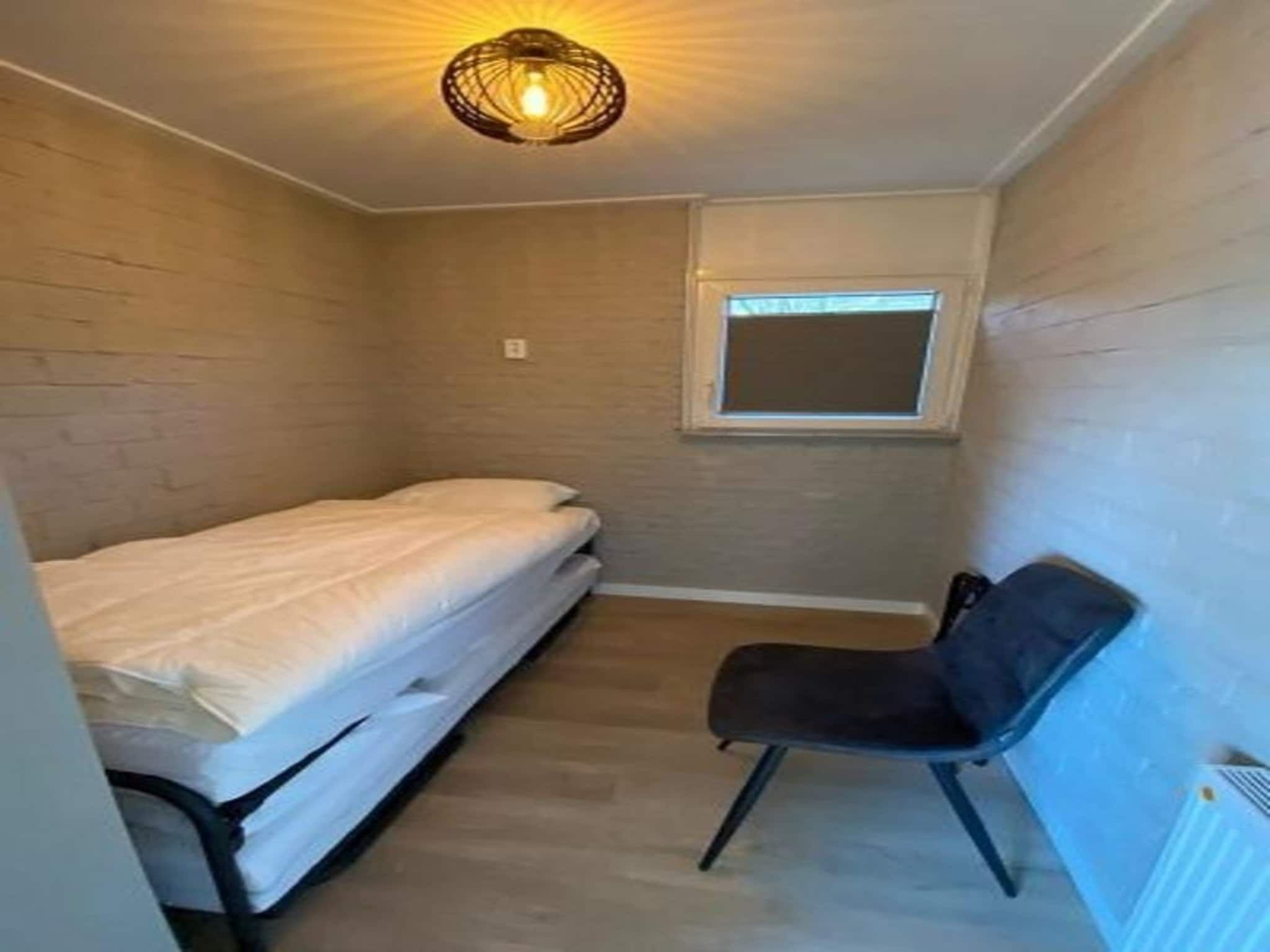 Een slaapkamer van Kloosterbos 4 in Sint Maartensbrug