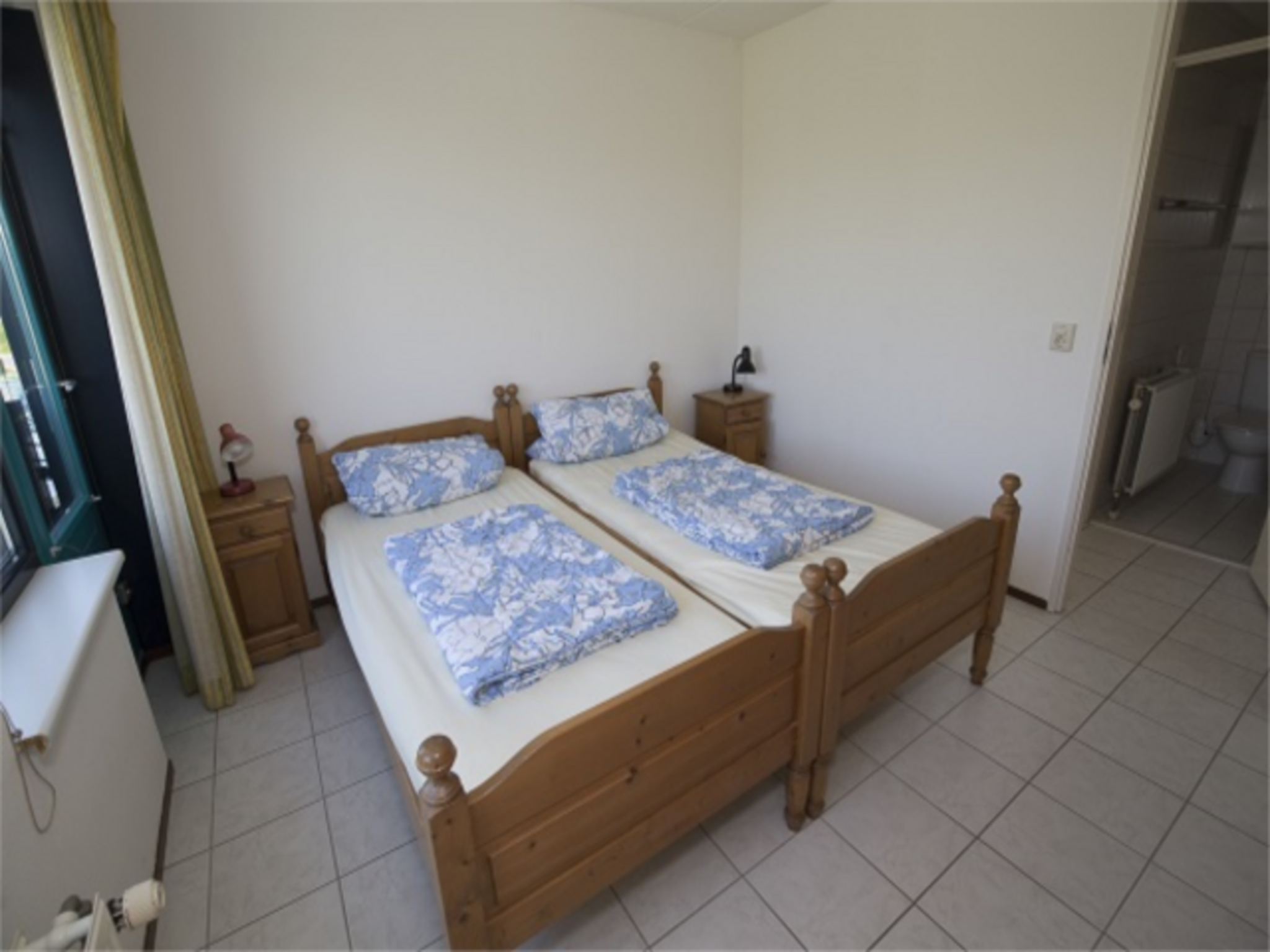 Een slaapkamer van Zeeweg 49 in Sint Maartenszee