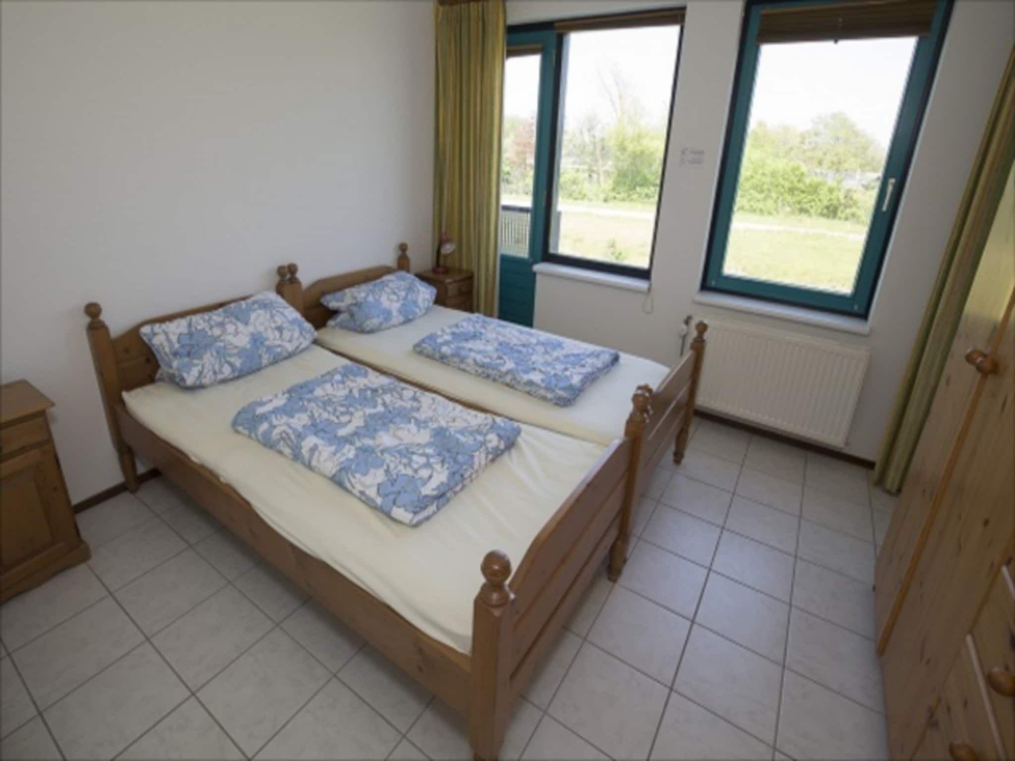 Een slaapkamer van Zeeweg 49 in Sint Maartenszee