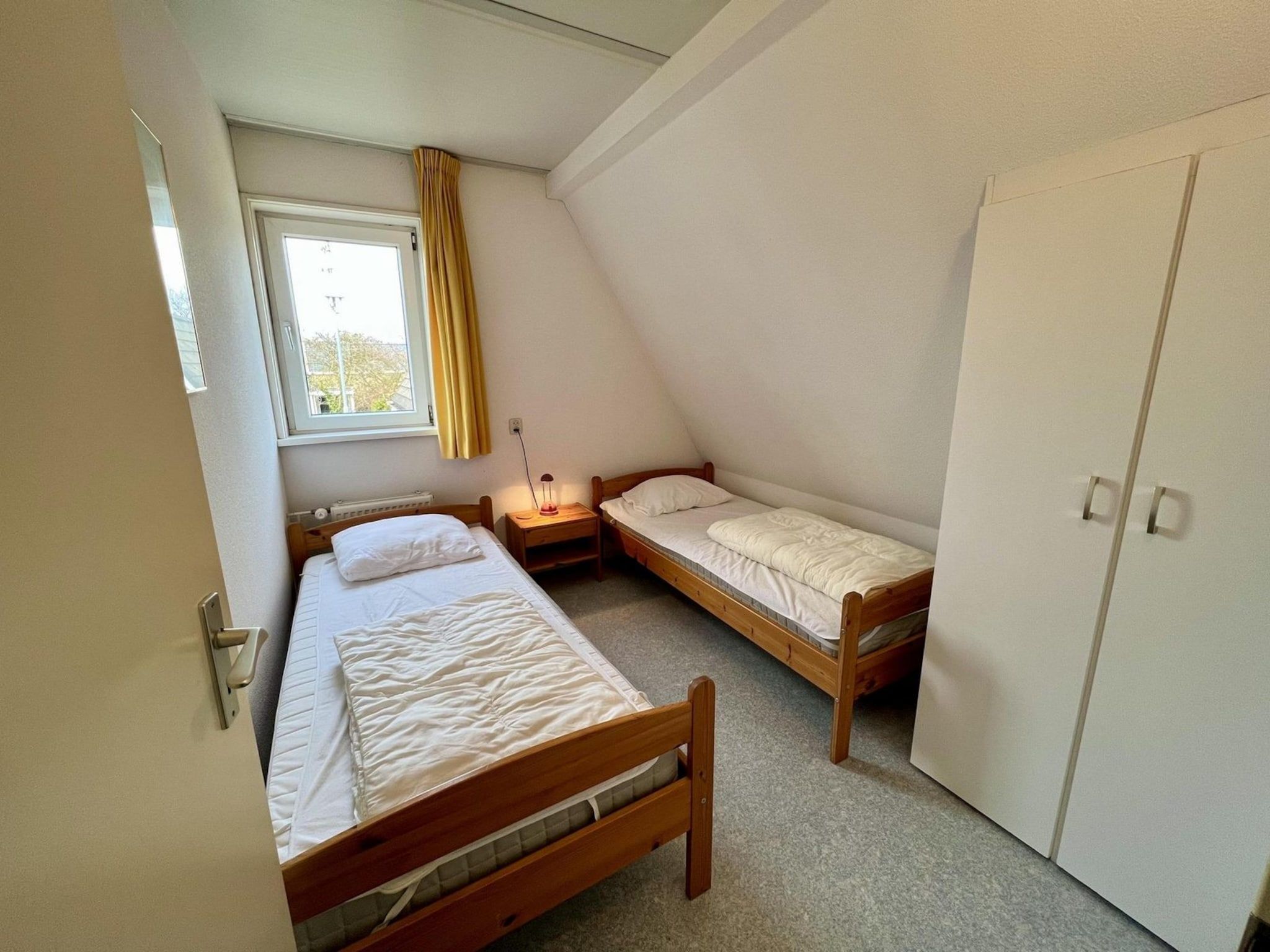 Een slaapkamer van Campanula 55 in Sint Maartenszee