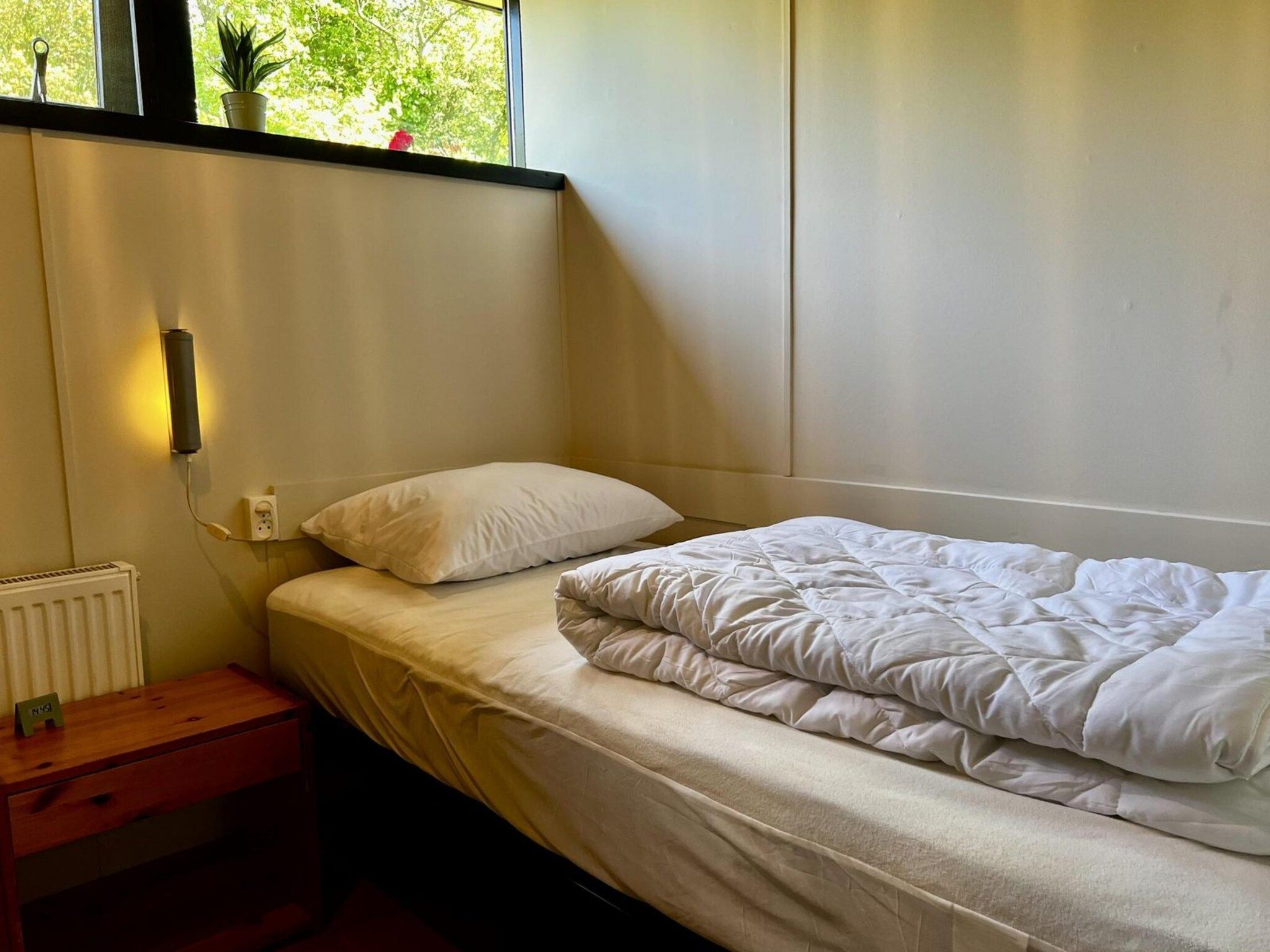 Een slaapkamer van Wildrijk 092 -"C'est la vie" in Sint Maartenszee