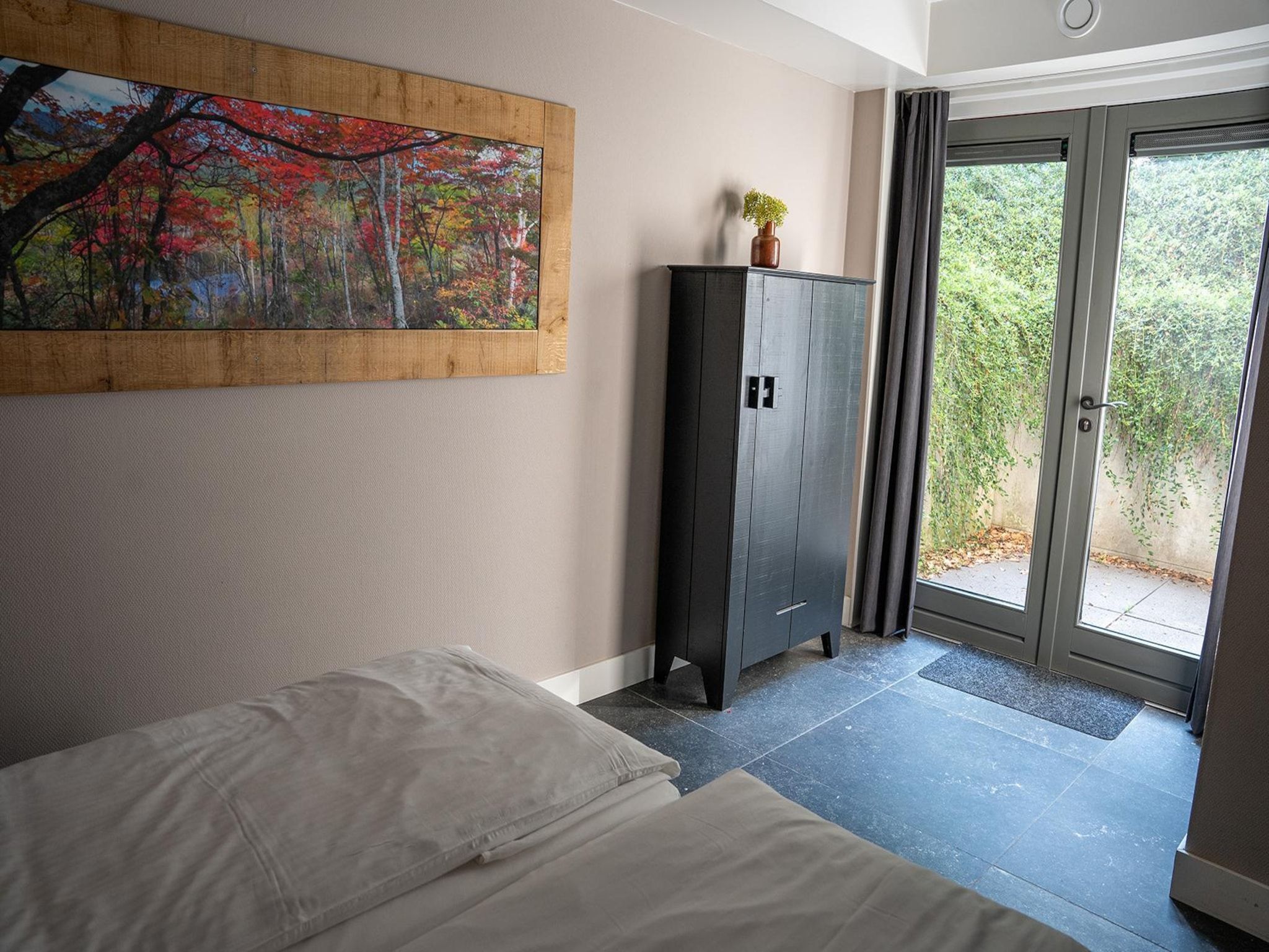 Een slaapkamer van Vlindervallei Boshuis 16p in Ermelo