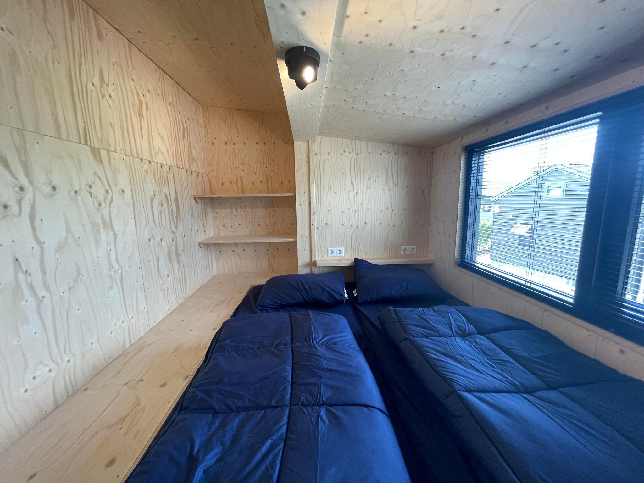 Een slaapkamer van Tiny House  4 personen in West-Graftdijk