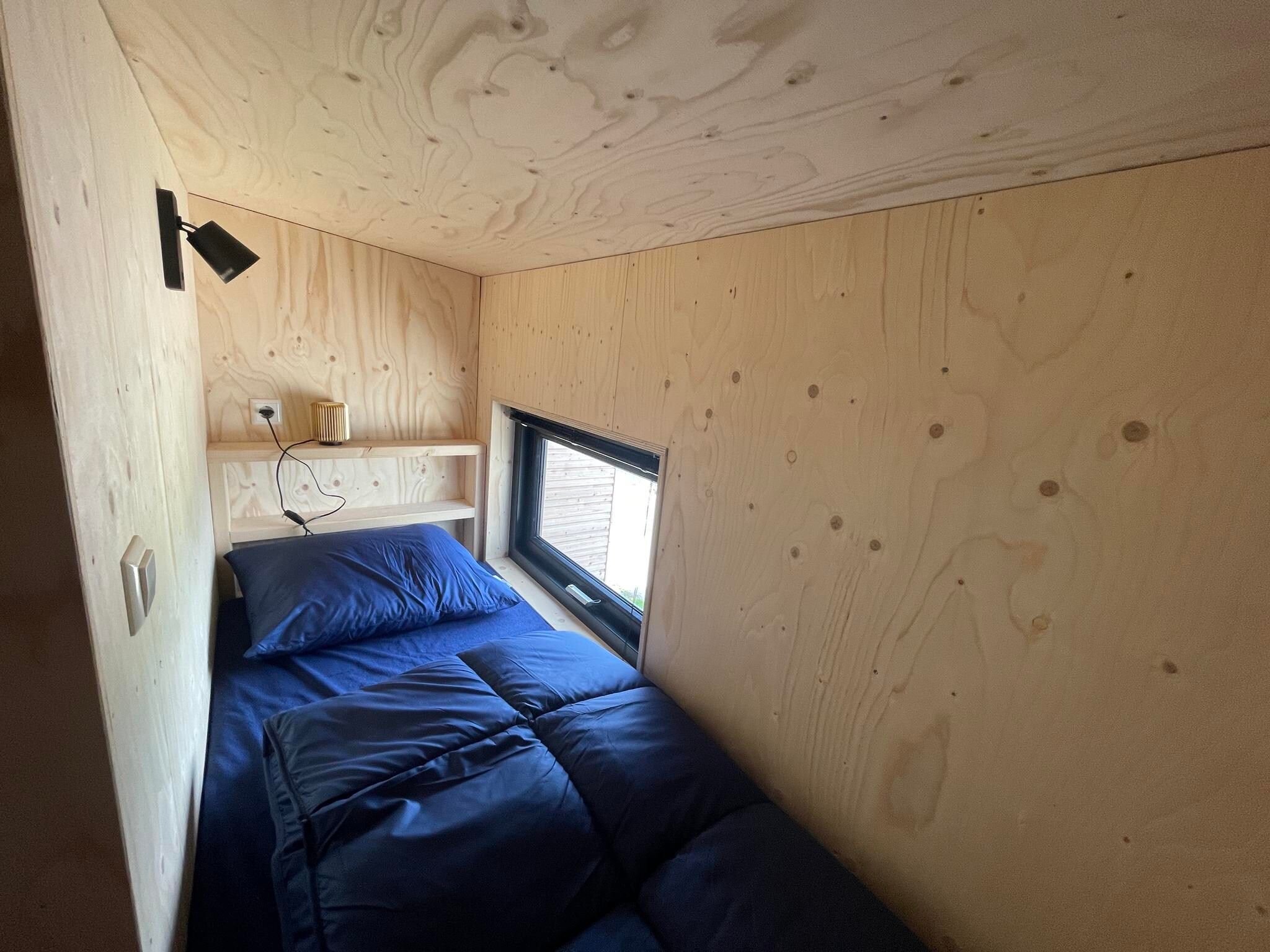 Een slaapkamer van Tiny House  4 personen in West-Graftdijk