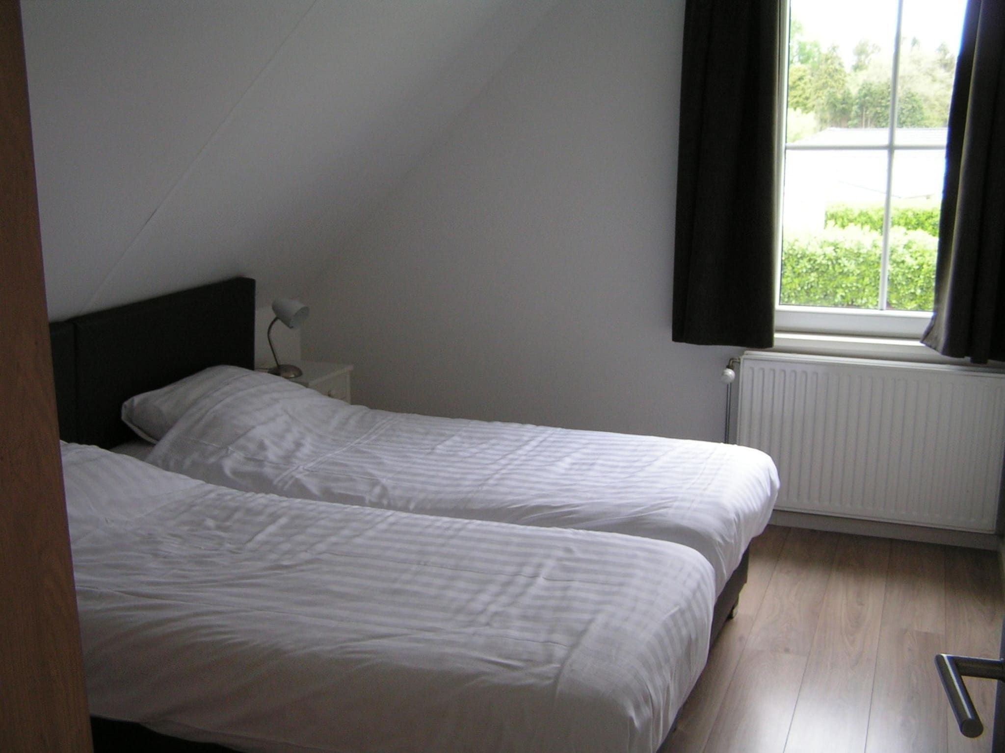 Een slaapkamer van Villa de Hertog 722 in Baarle-nassau