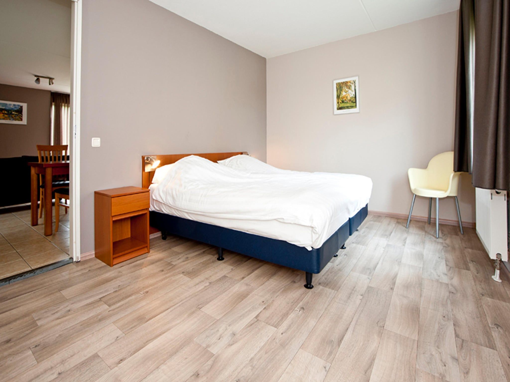 Een slaapkamer van Boswoning in Heel