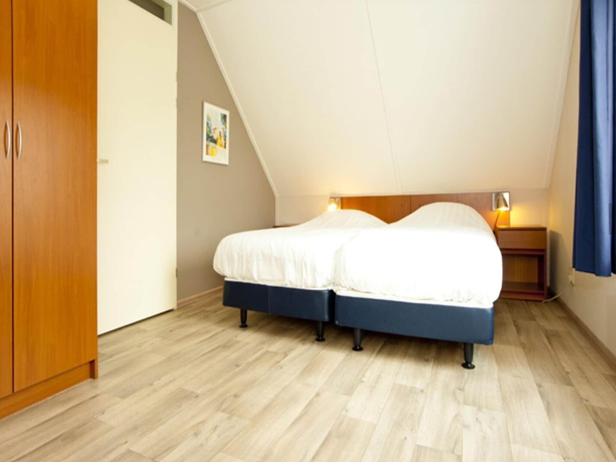 Een slaapkamer van Boswoning in Heel