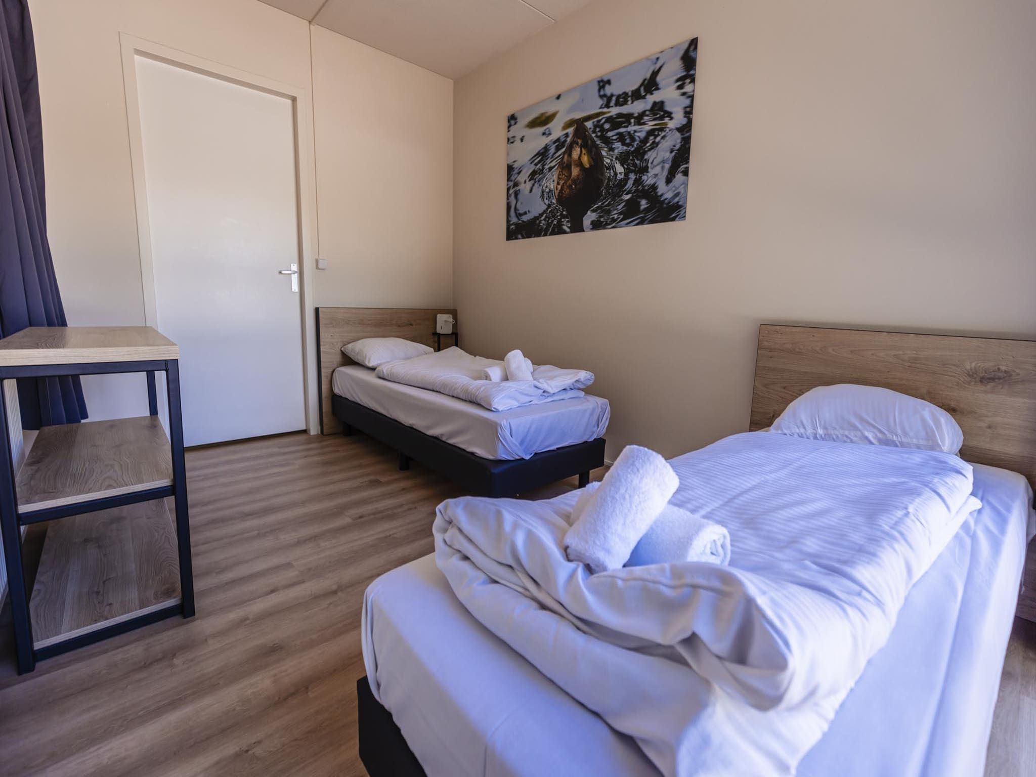 Een slaapkamer van 12 - Persons Family Bungalow in Ewijk