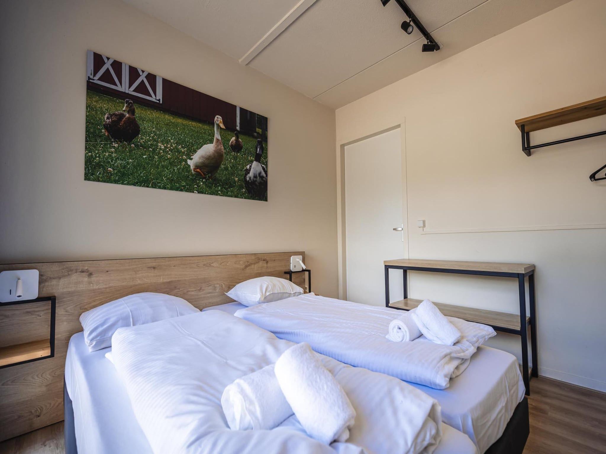 Een slaapkamer van 12 - Persons Family Bungalow in Ewijk