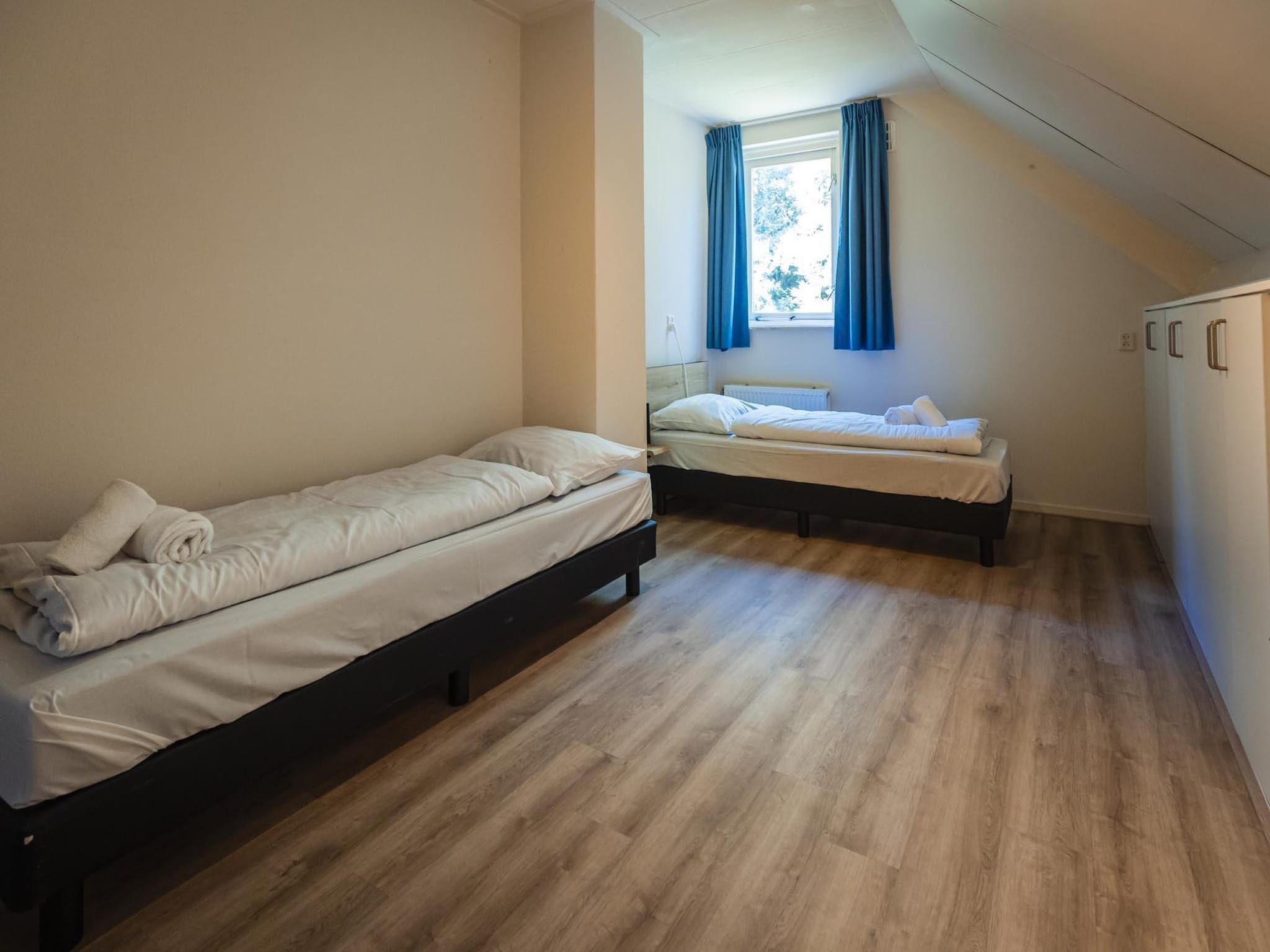 Een slaapkamer van 12 - Persons Family Bungalow in Ewijk