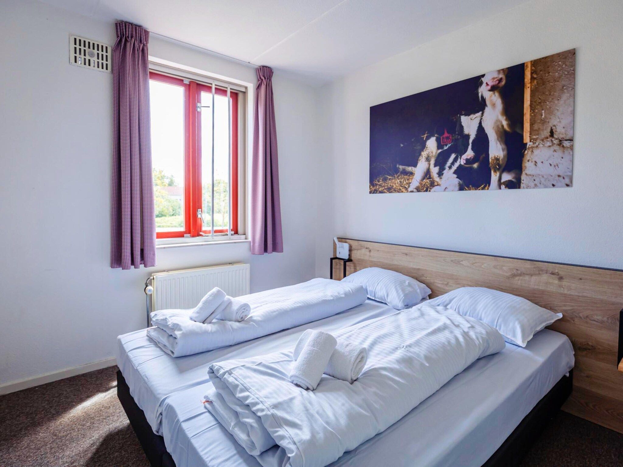 Een slaapkamer van 16 - Persons Family bungalow in Ewijk