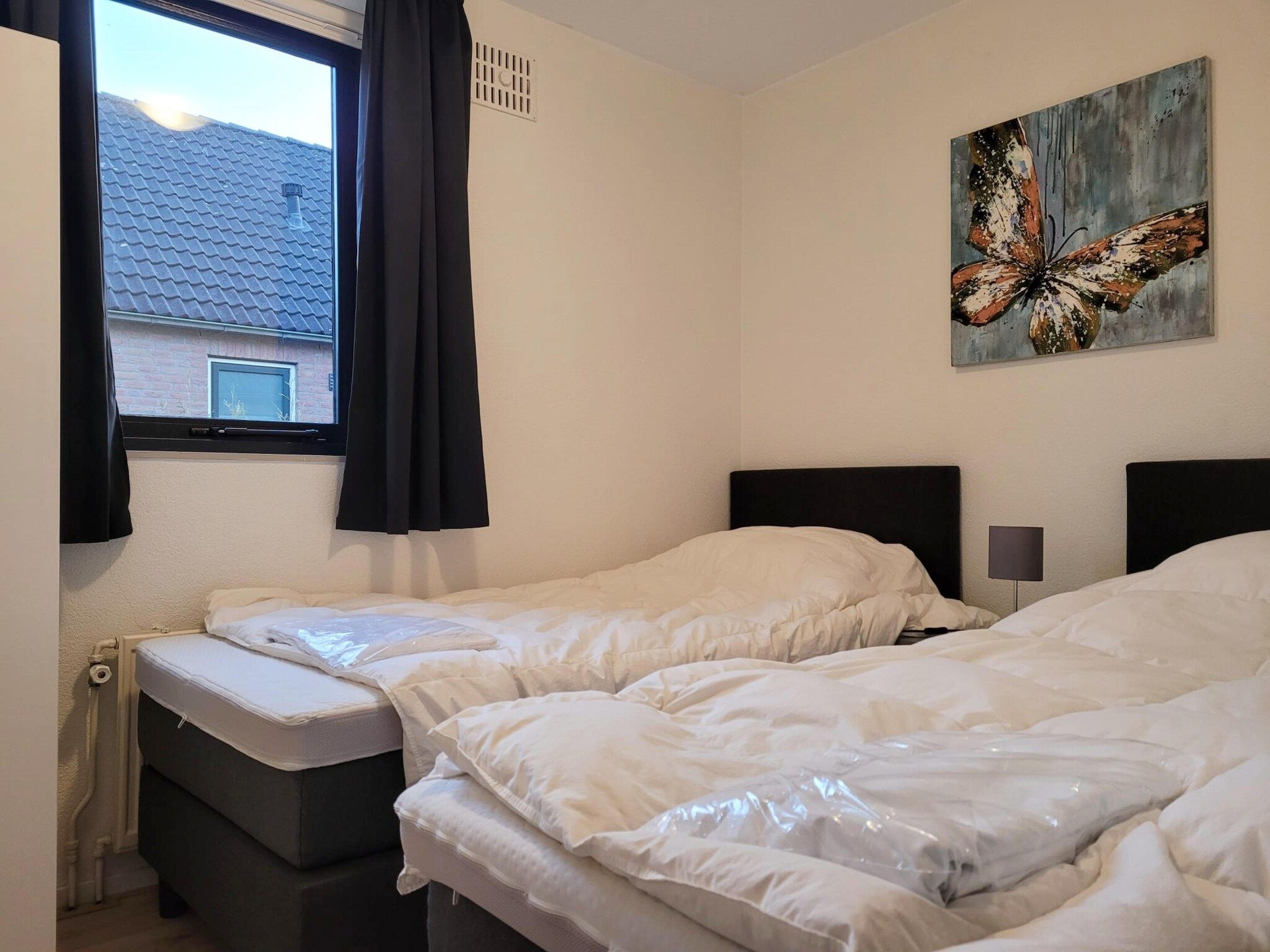 Een slaapkamer van 6 - Person Forest Pet & Family Bungalow in Ewijk