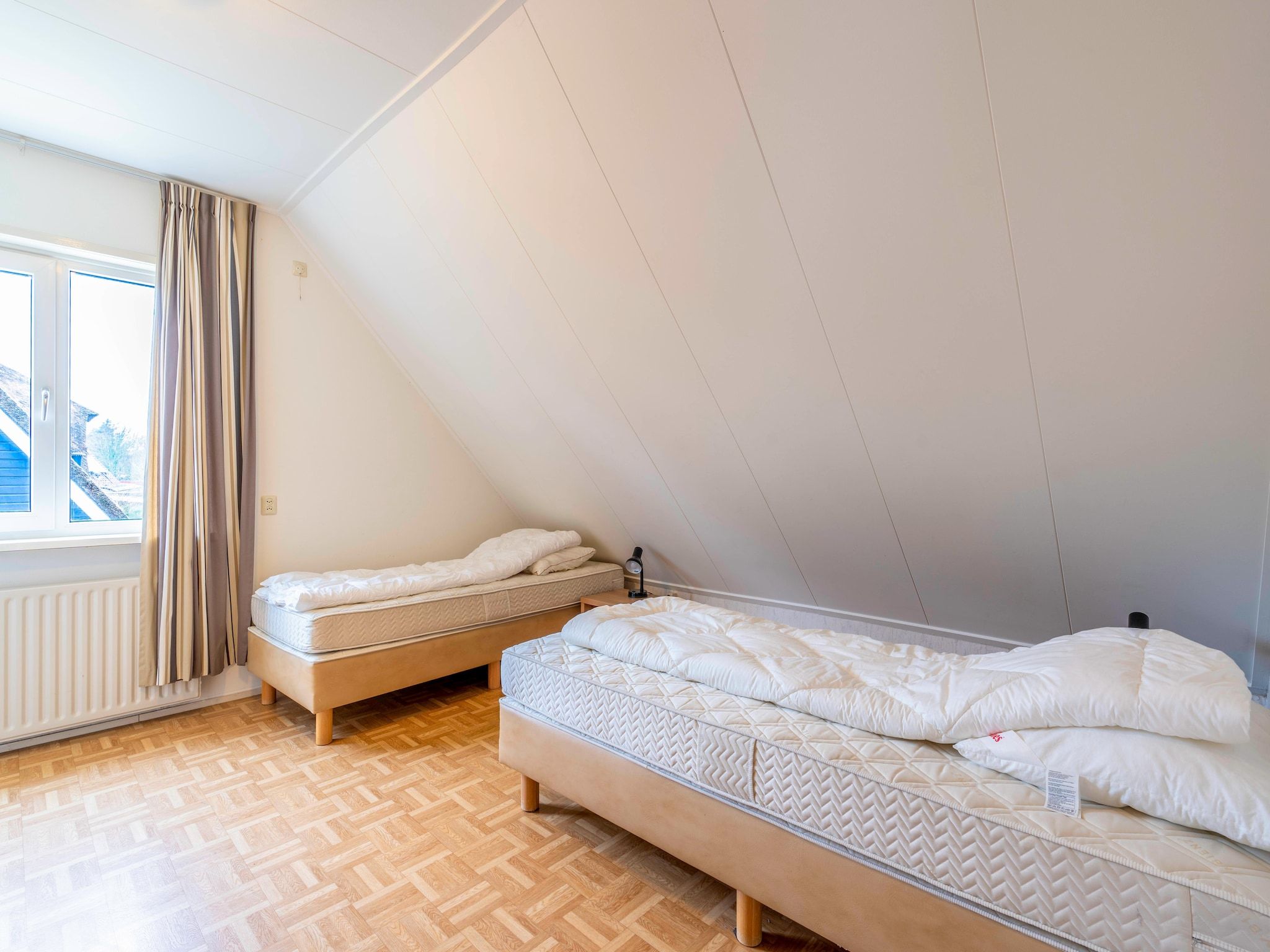 Een slaapkamer van Ruijslaan 69 - Huis Ter Duin in De Koog