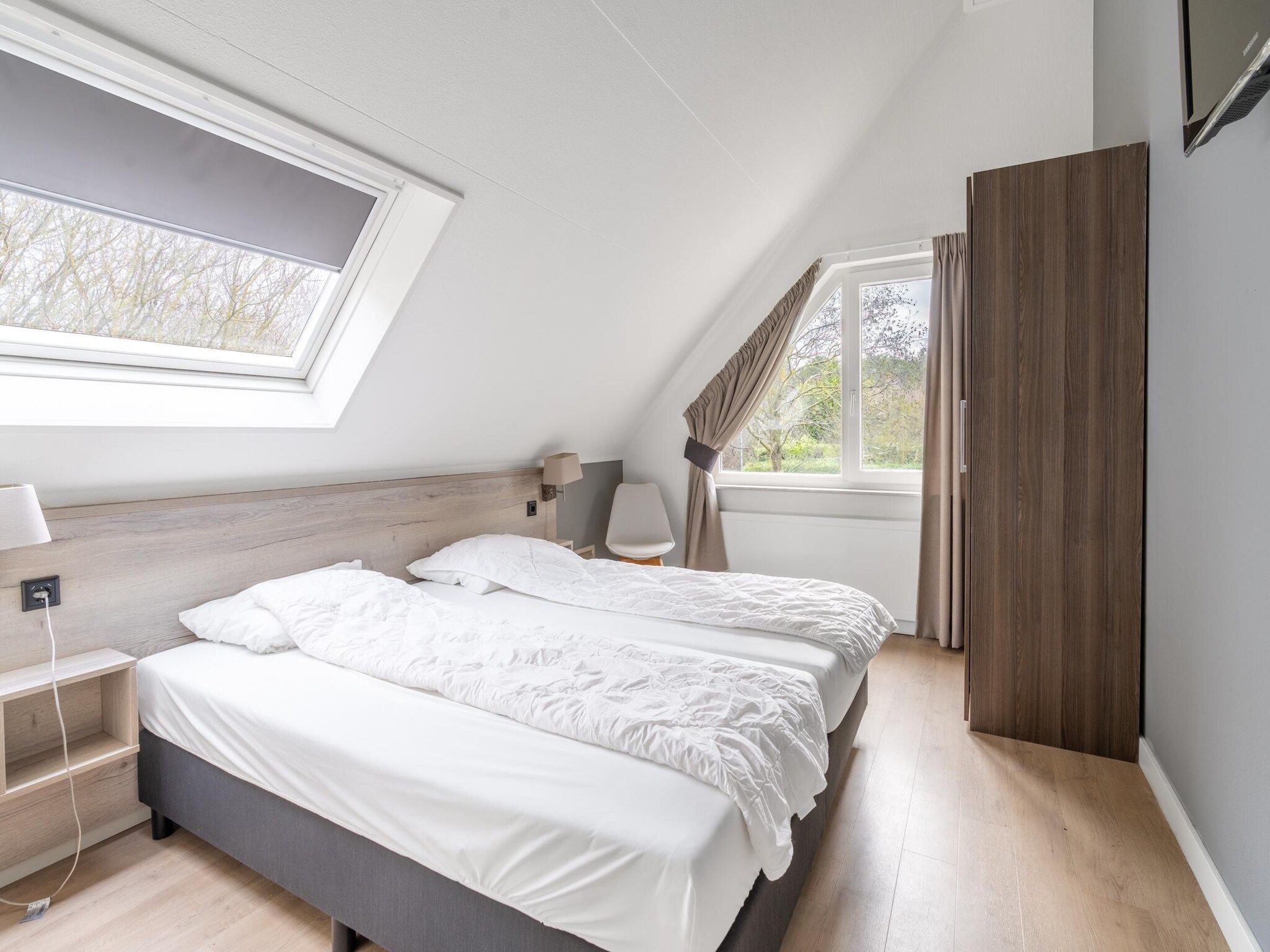 Een slaapkamer van Kamperfoelie 73 in De Koog