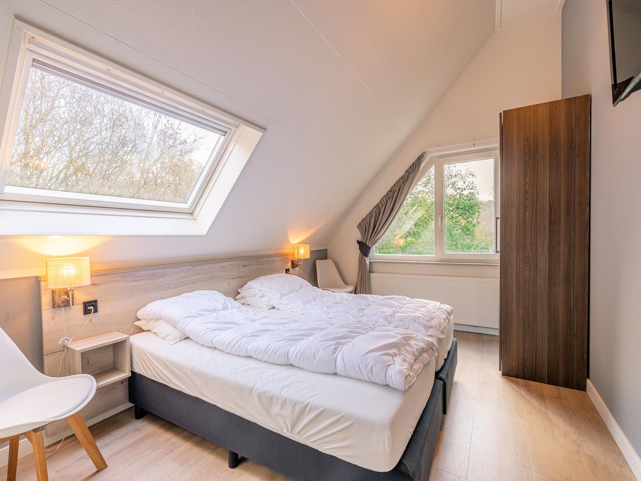 Een slaapkamer van Kamperfoelie 73 in De Koog