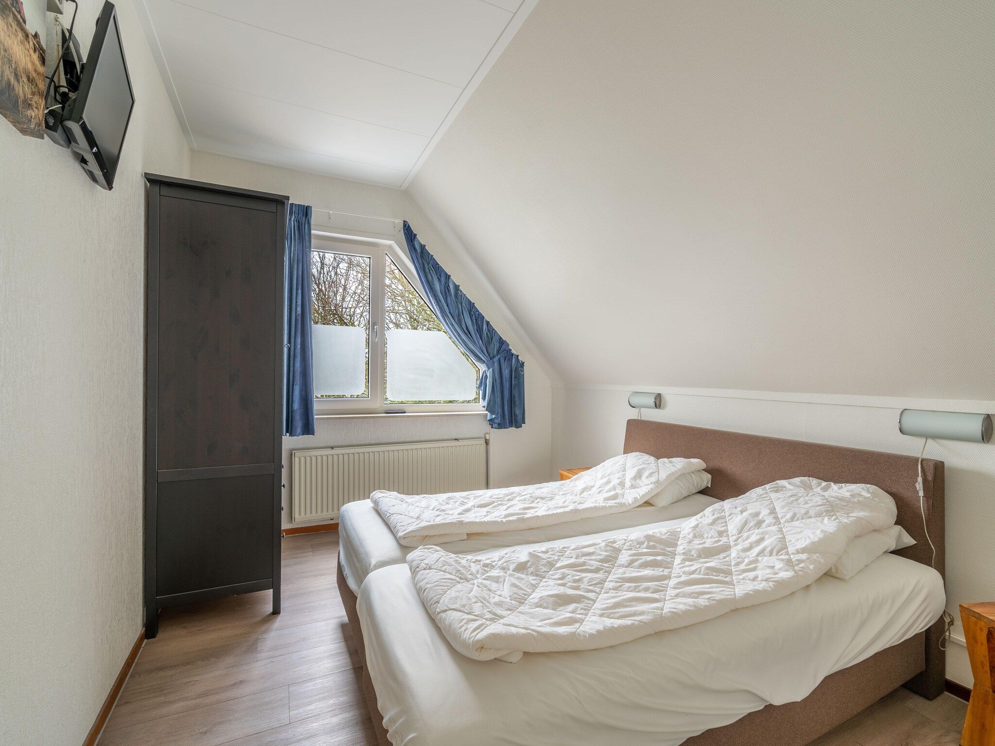 Een slaapkamer van Kamperfoelie 43 in De Koog