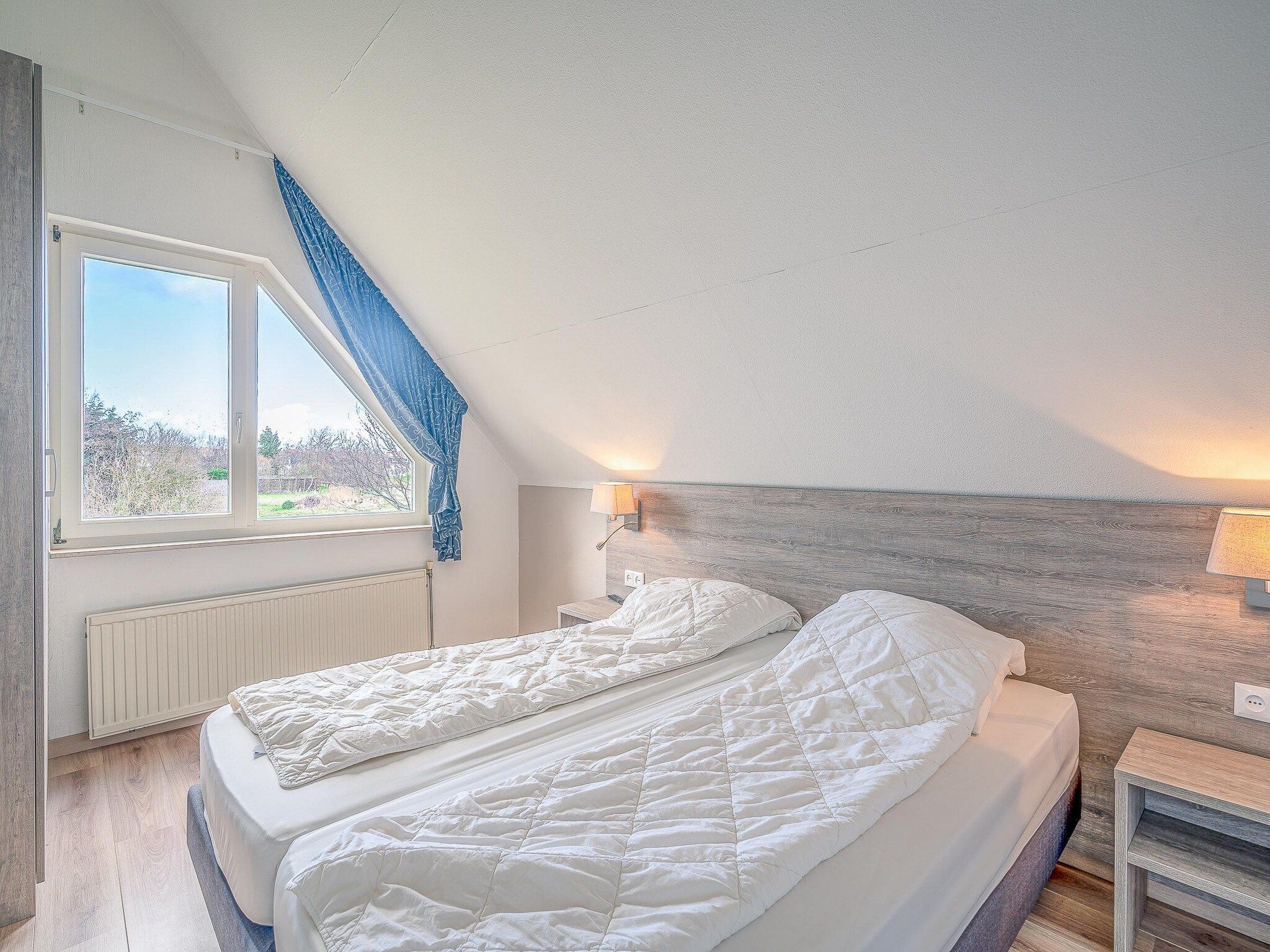 Een slaapkamer van Kamperfoelie 55 in De Koog