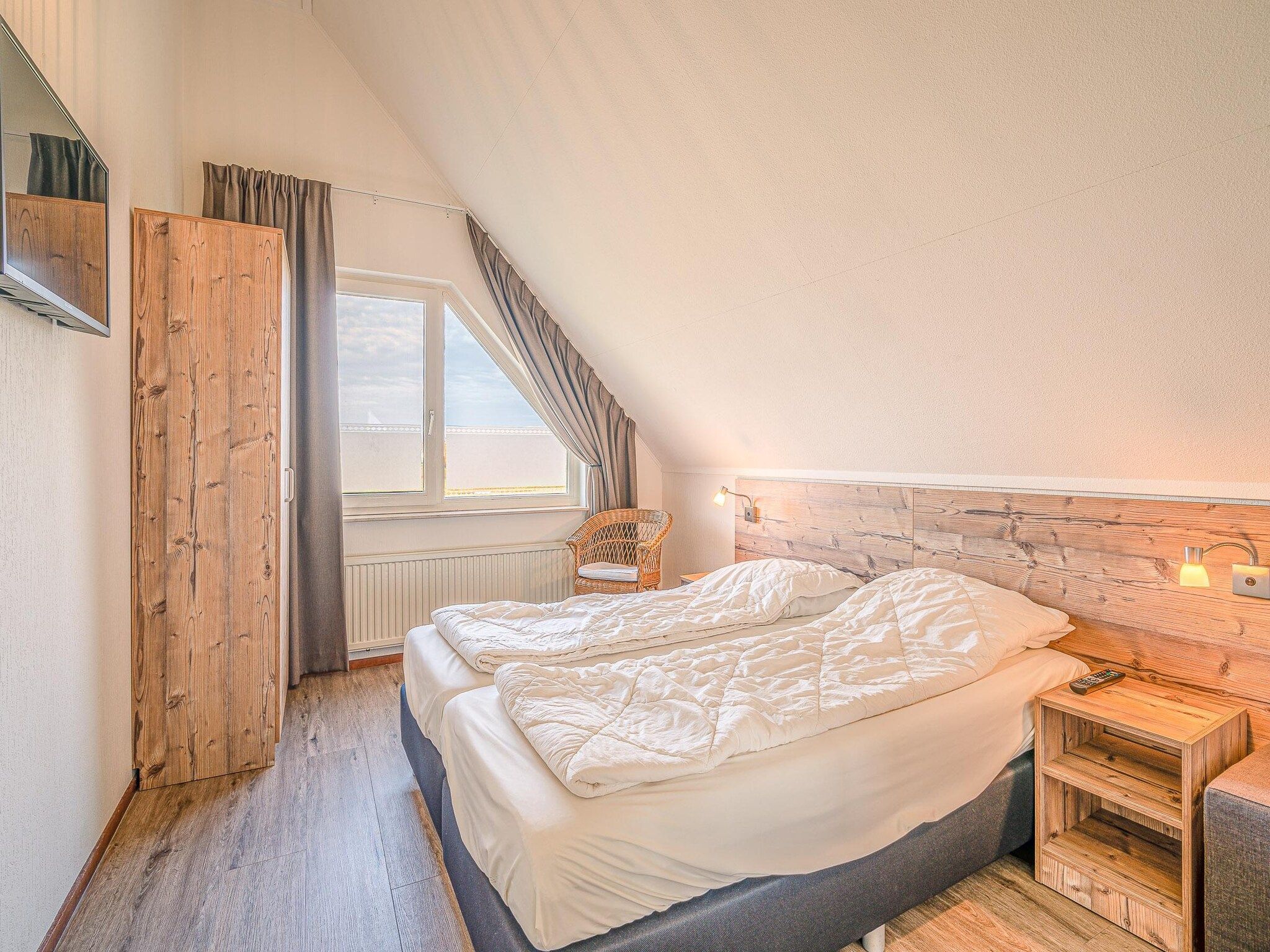 Een slaapkamer van Kamperfoelie 71 in De Koog