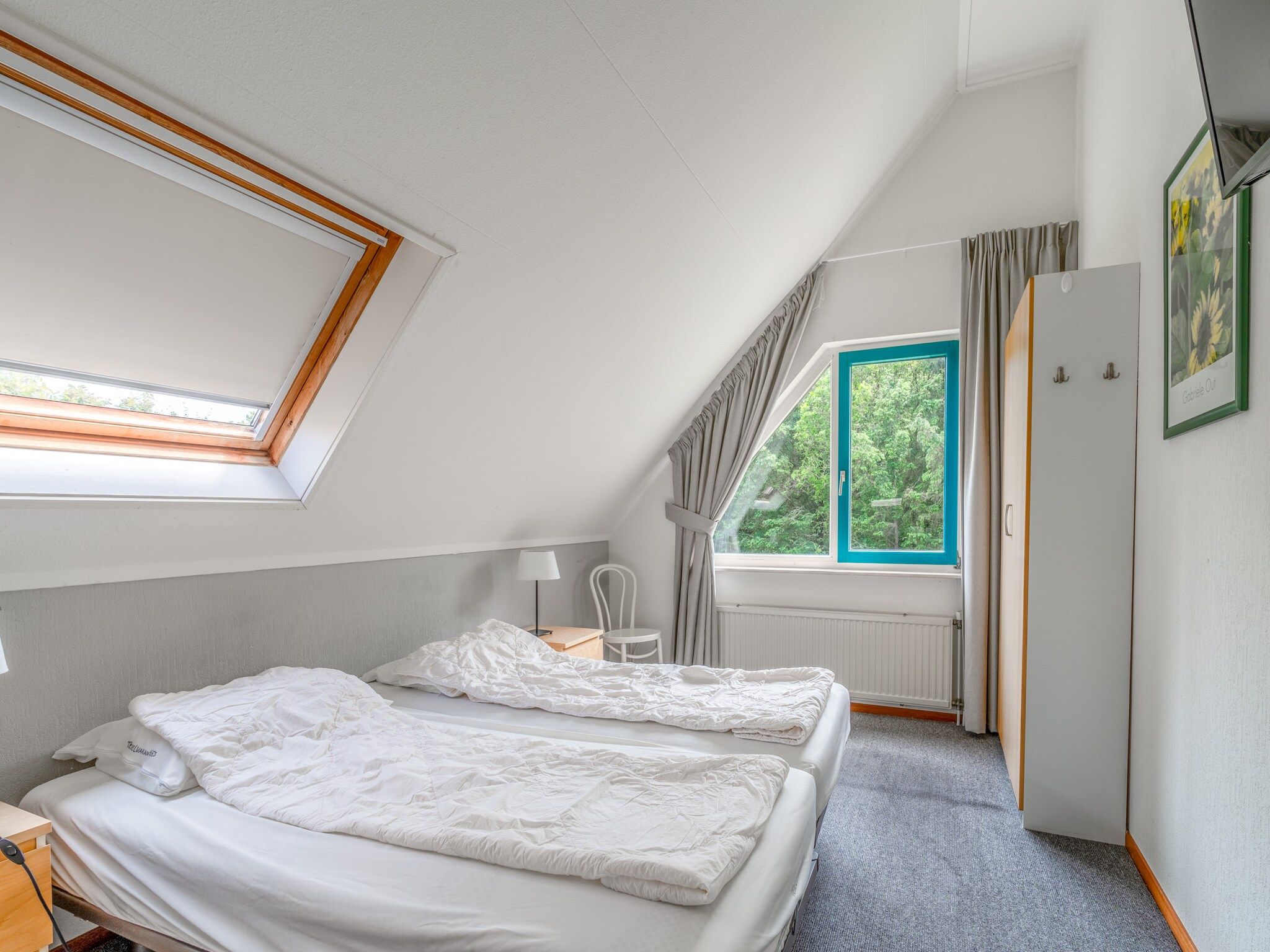 Een slaapkamer van Kamperfoelie 85 in De Koog