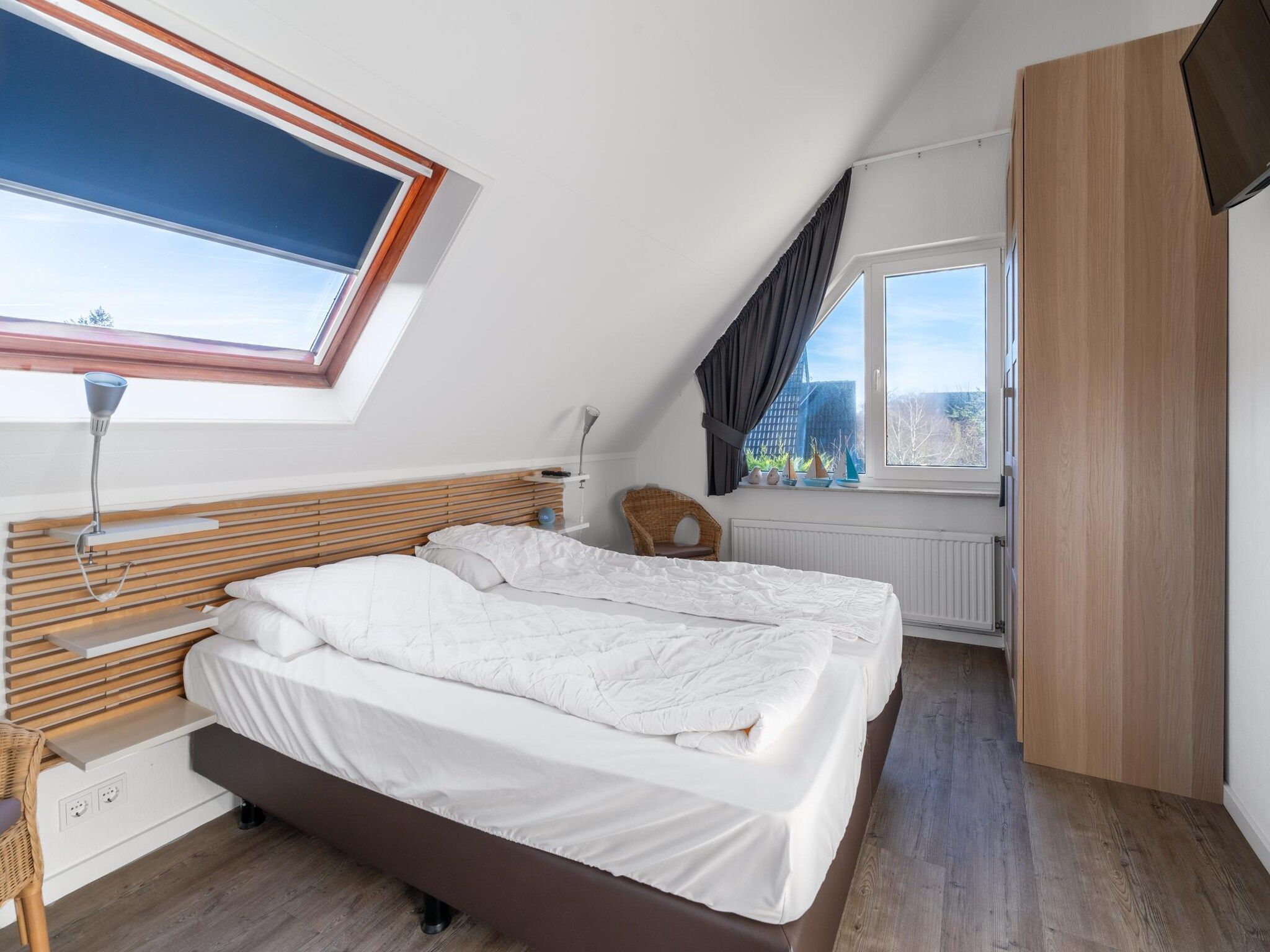 Een slaapkamer van Kamperfoelie 75 in De Koog