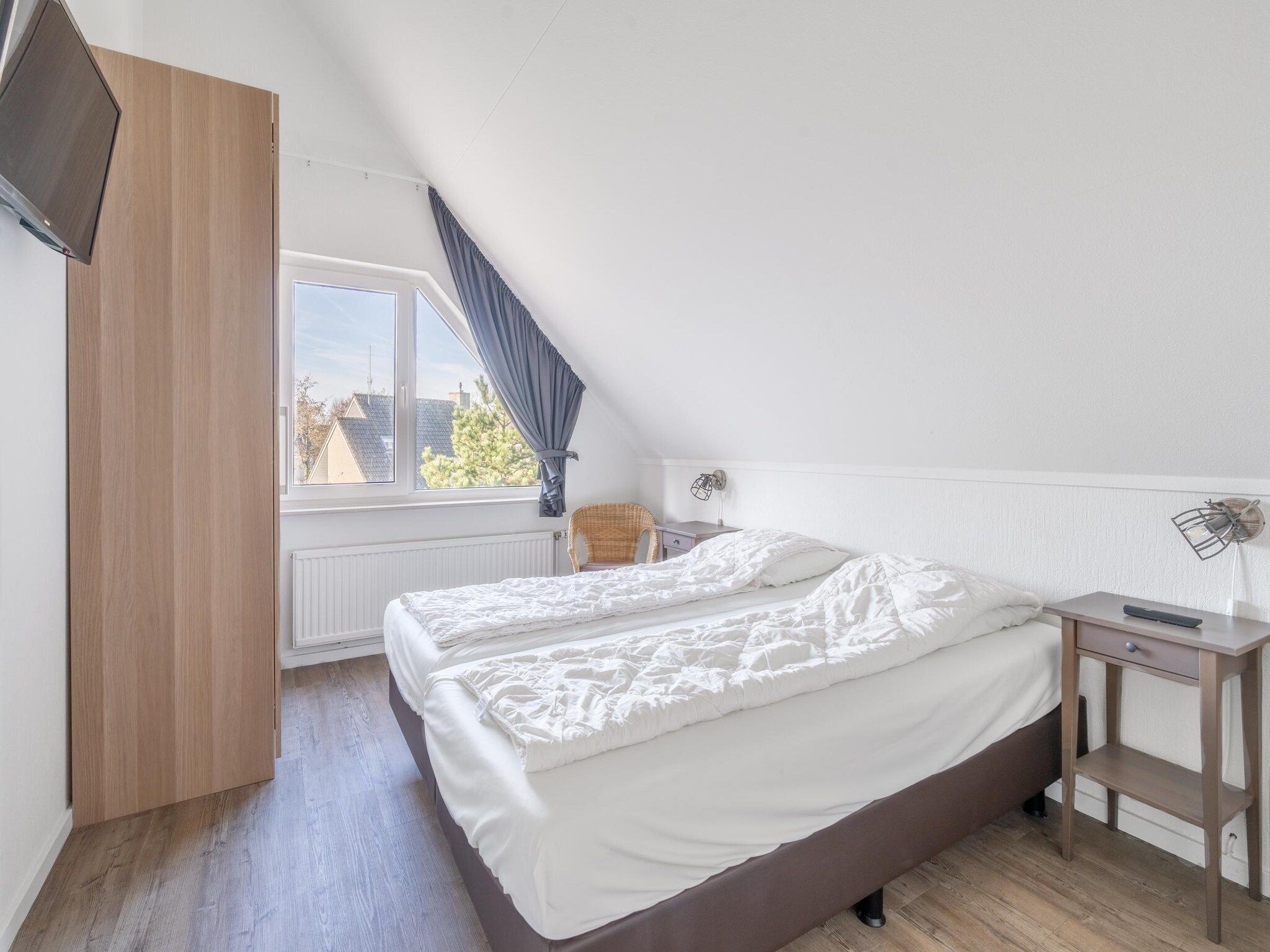 Een slaapkamer van Kamperfoelie 75 in De Koog