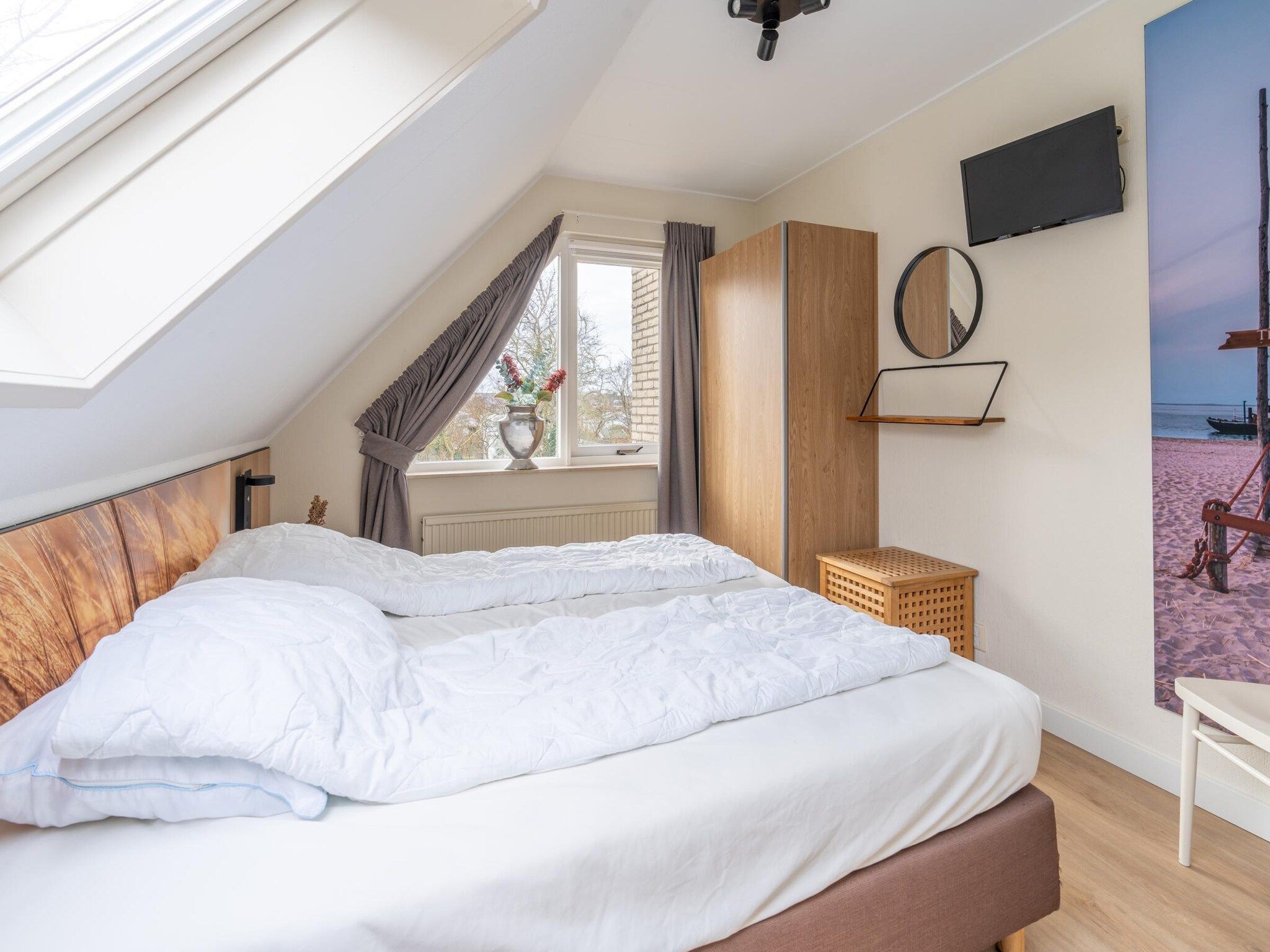 Een slaapkamer van Kamperfoelie 33 in De Koog