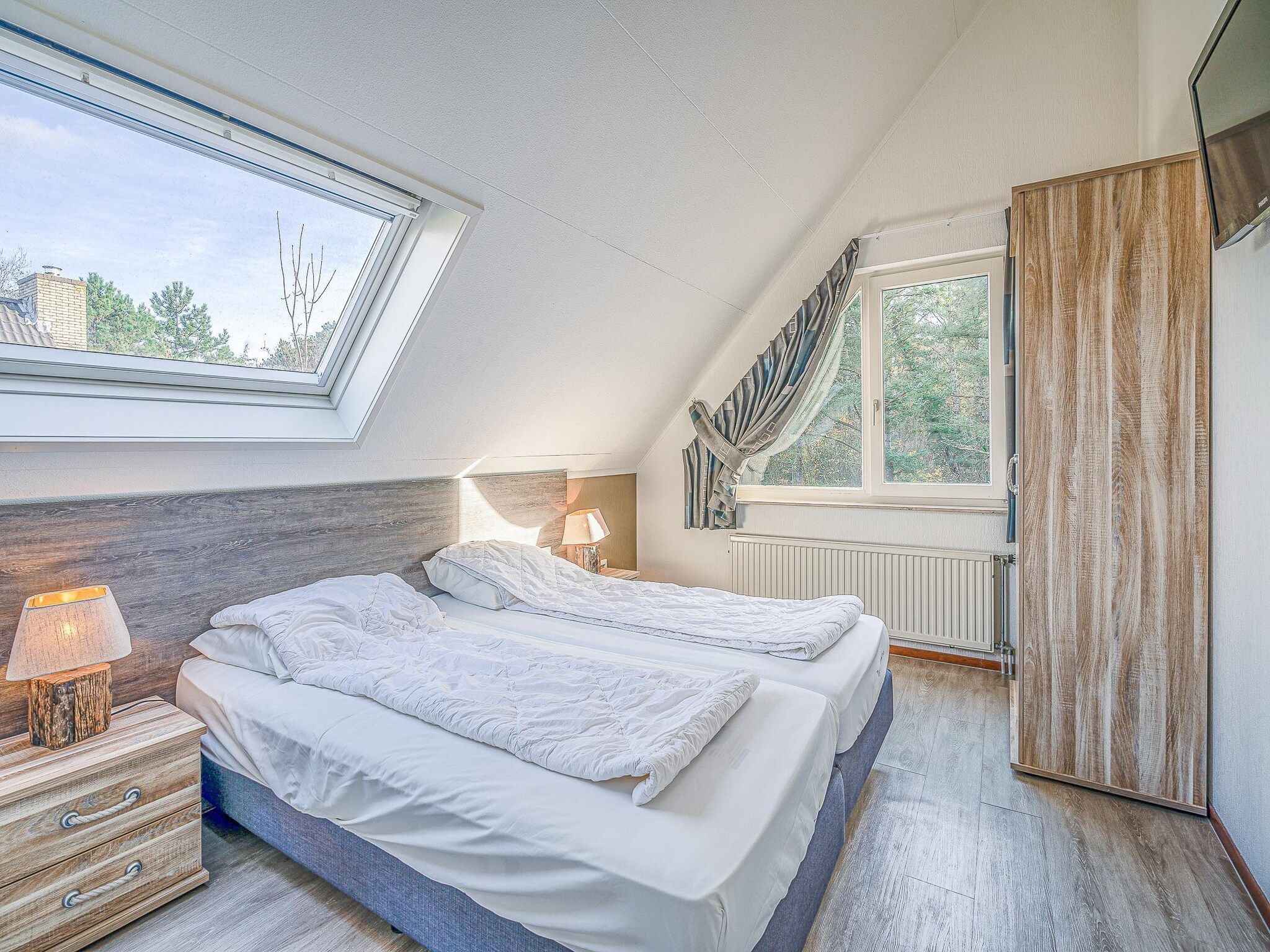 Een slaapkamer van Kamperfoelie 31 in De Koog