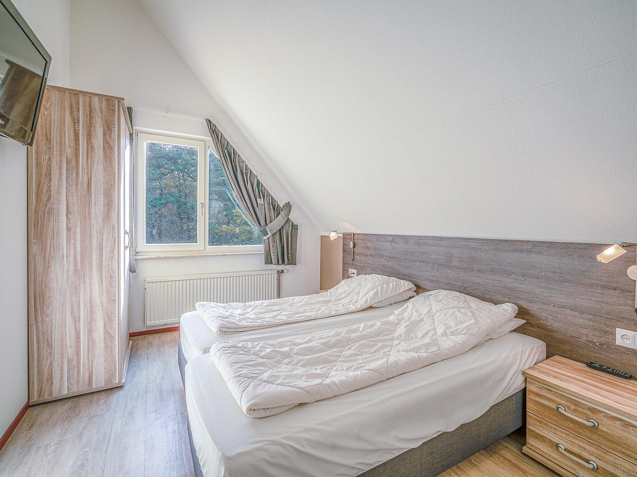 Een slaapkamer van Kamperfoelie 31 in De Koog