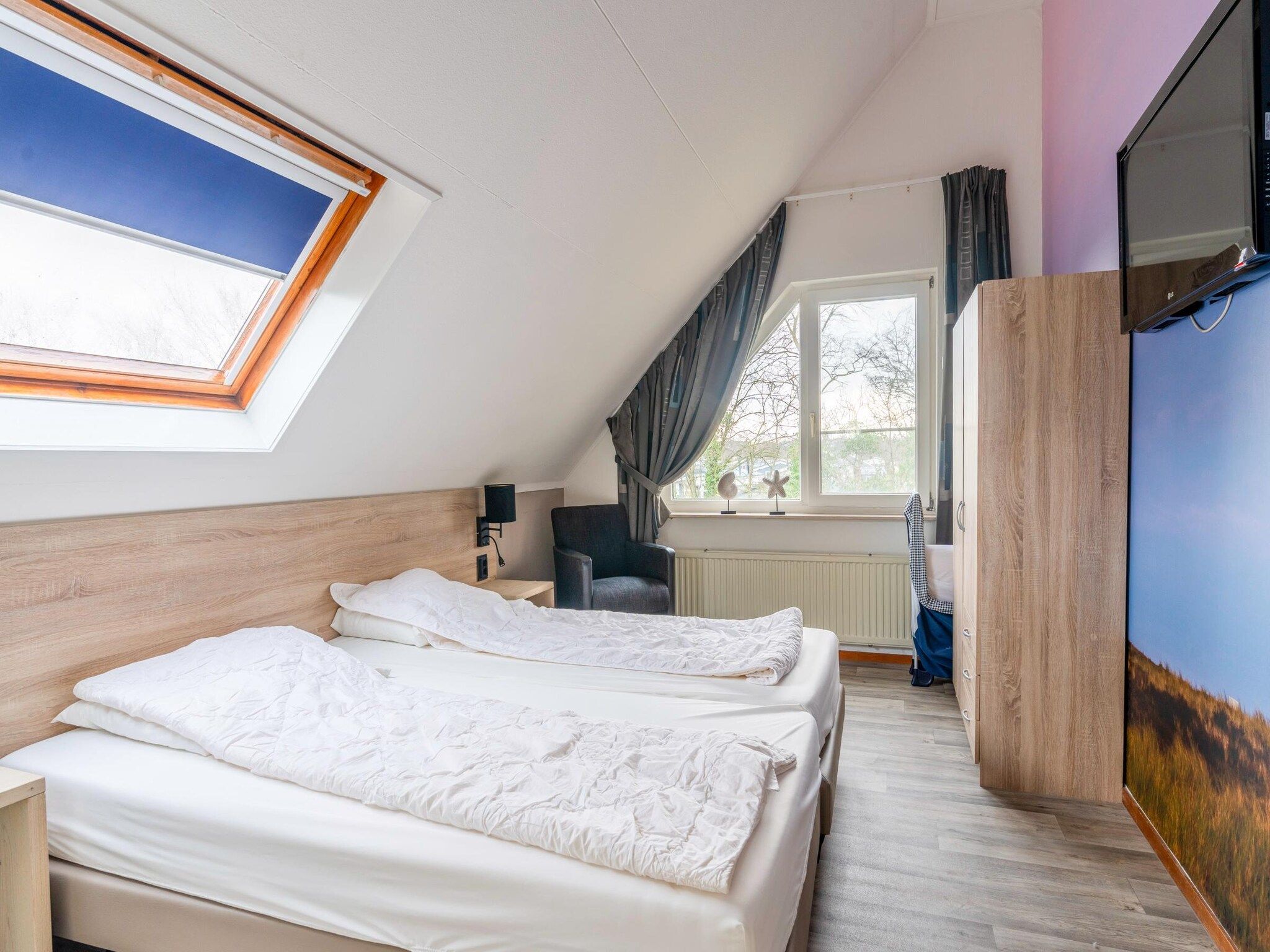 Een slaapkamer van Kamperfoelie 45 in De Koog