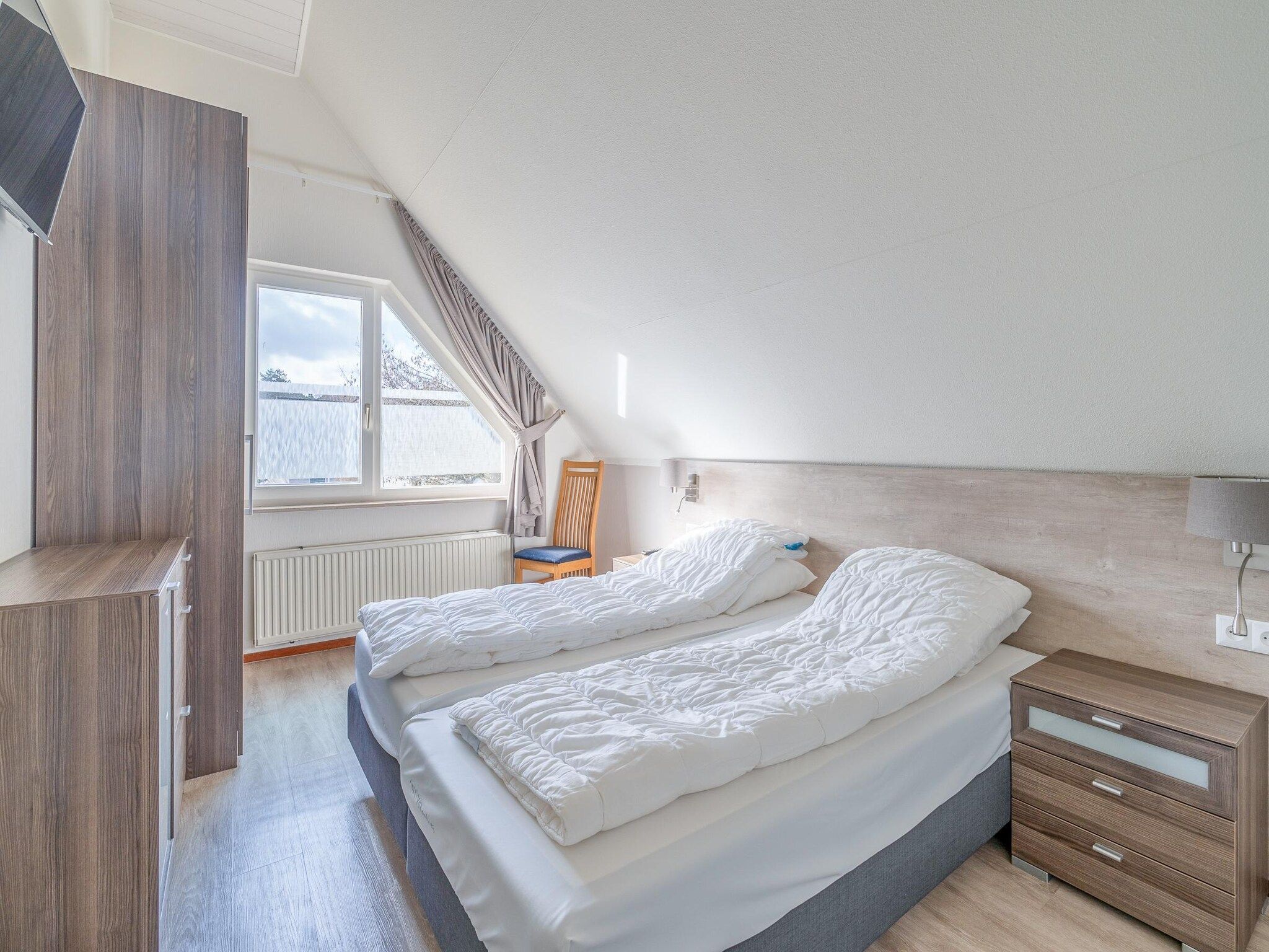 Een slaapkamer van Kamperfoelie 49 in De Koog