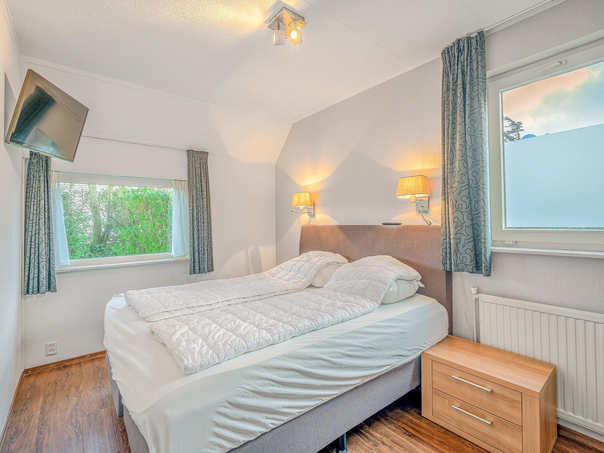 Een slaapkamer van Kamperfoelie 51 in De Koog