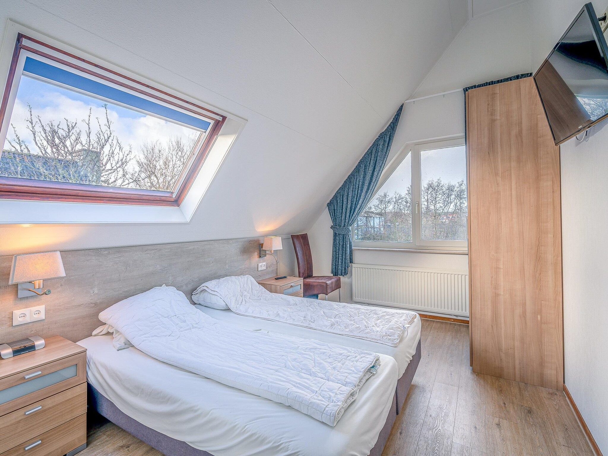 Een slaapkamer van Kamperfoelie 51 in De Koog