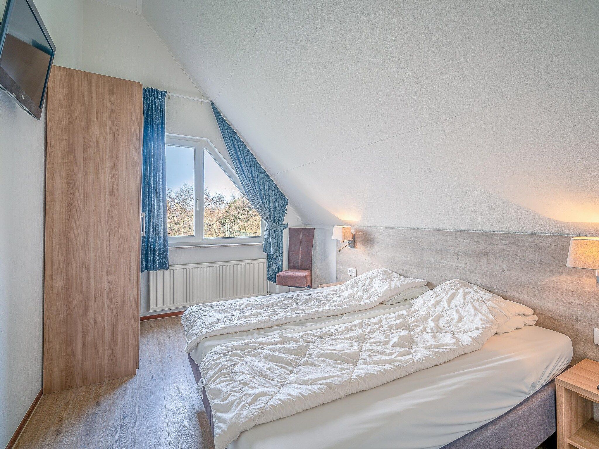 Een slaapkamer van Kamperfoelie 51 in De Koog