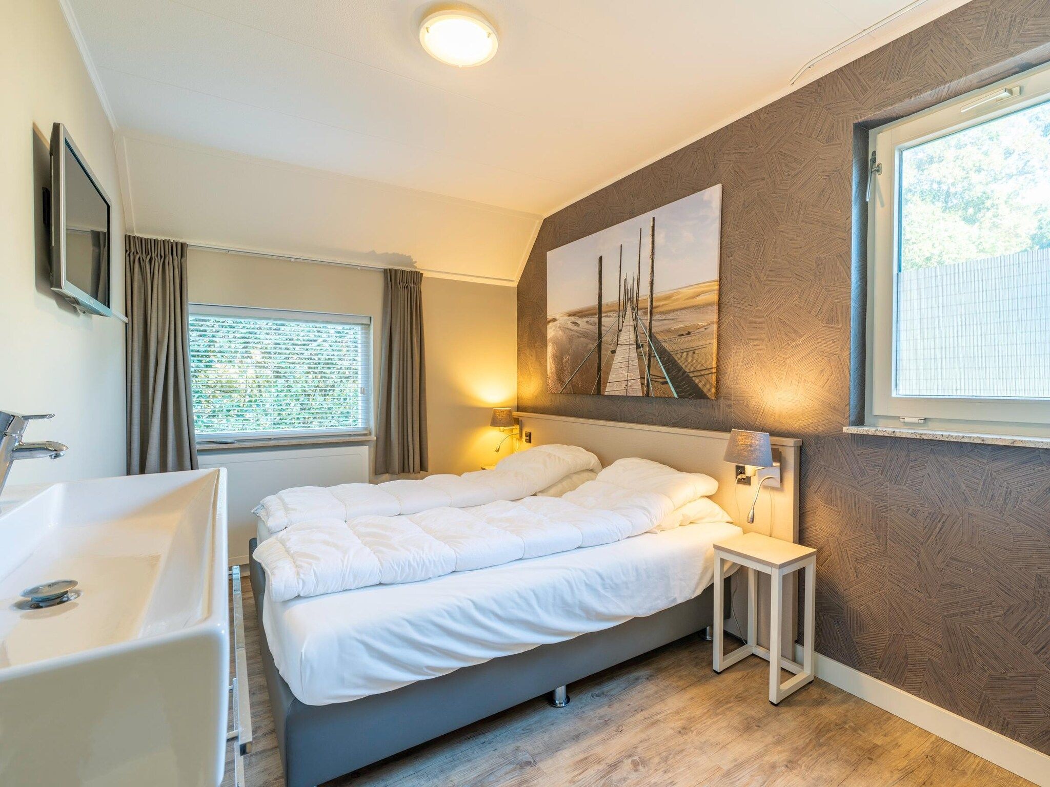 Een slaapkamer van Kamperfoelie 57 in De Koog