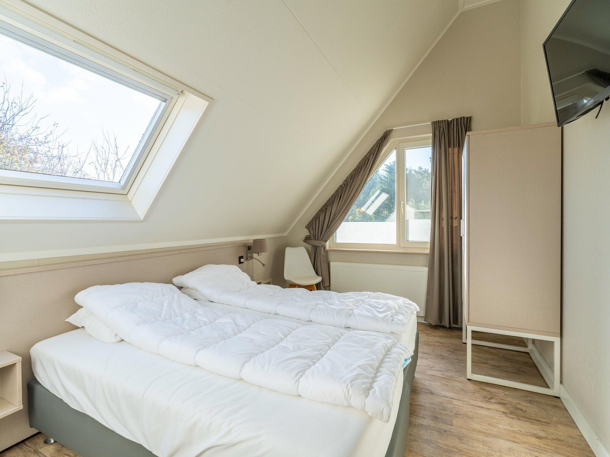 Een slaapkamer van Kamperfoelie 57 in De Koog