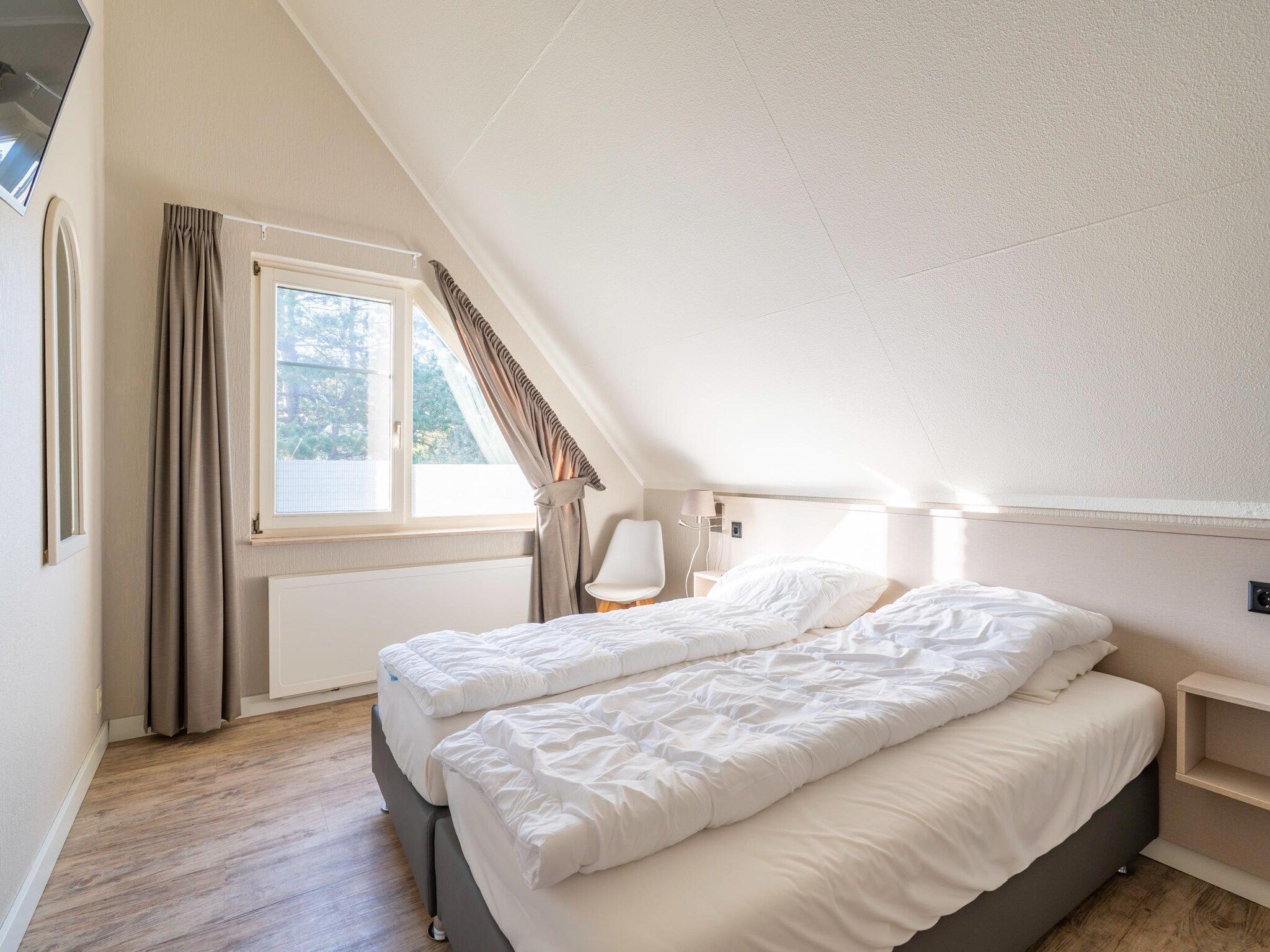 Een slaapkamer van Kamperfoelie 57 in De Koog