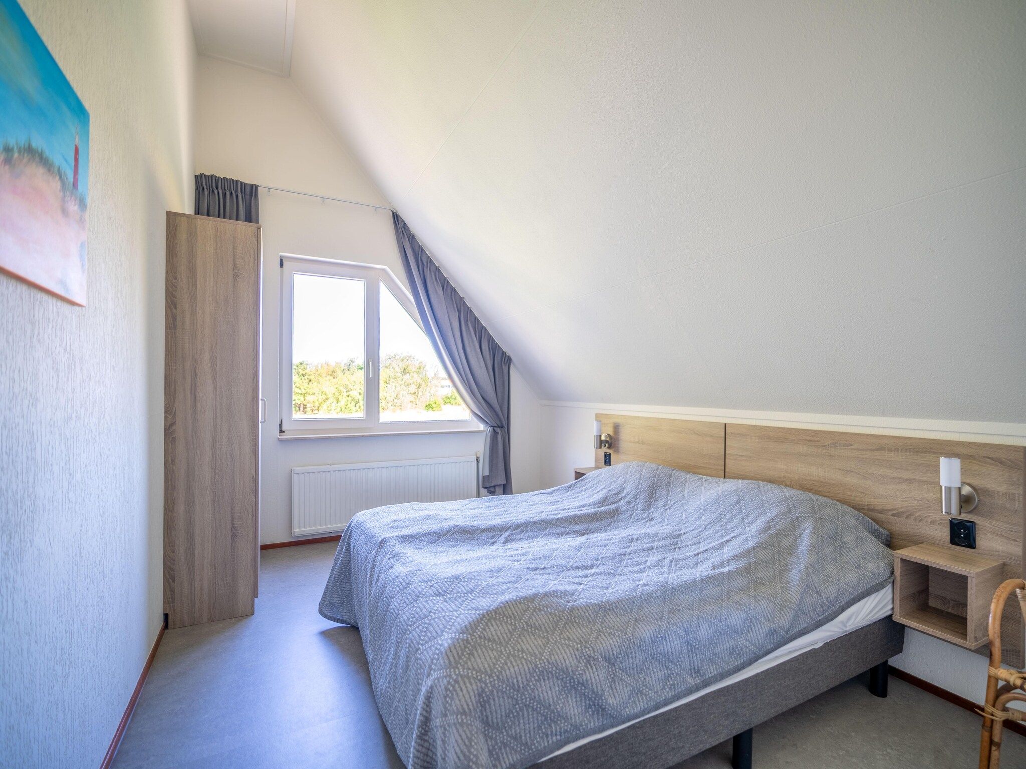 Een slaapkamer van Kamperfoelie 67 in De Koog