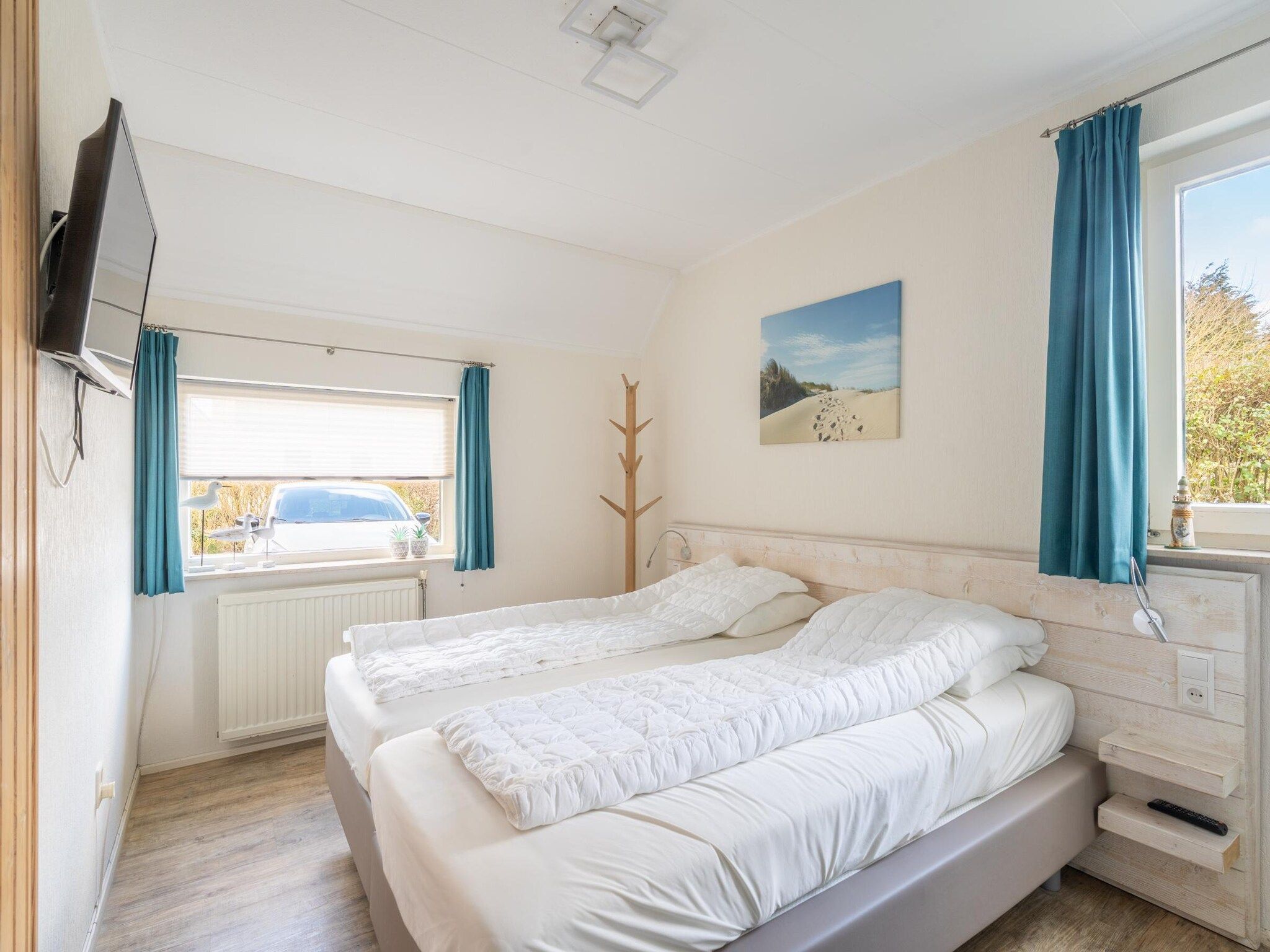 Een slaapkamer van Kamperfoelie 81 in De Koog