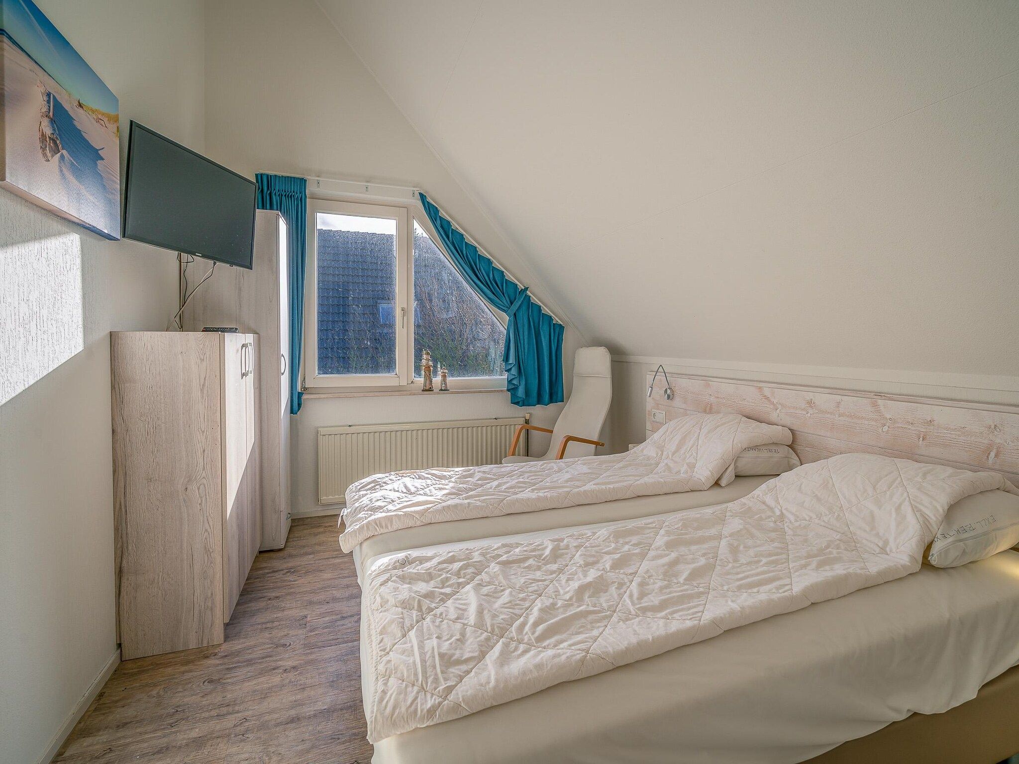 Een slaapkamer van Kamperfoelie 81 in De Koog