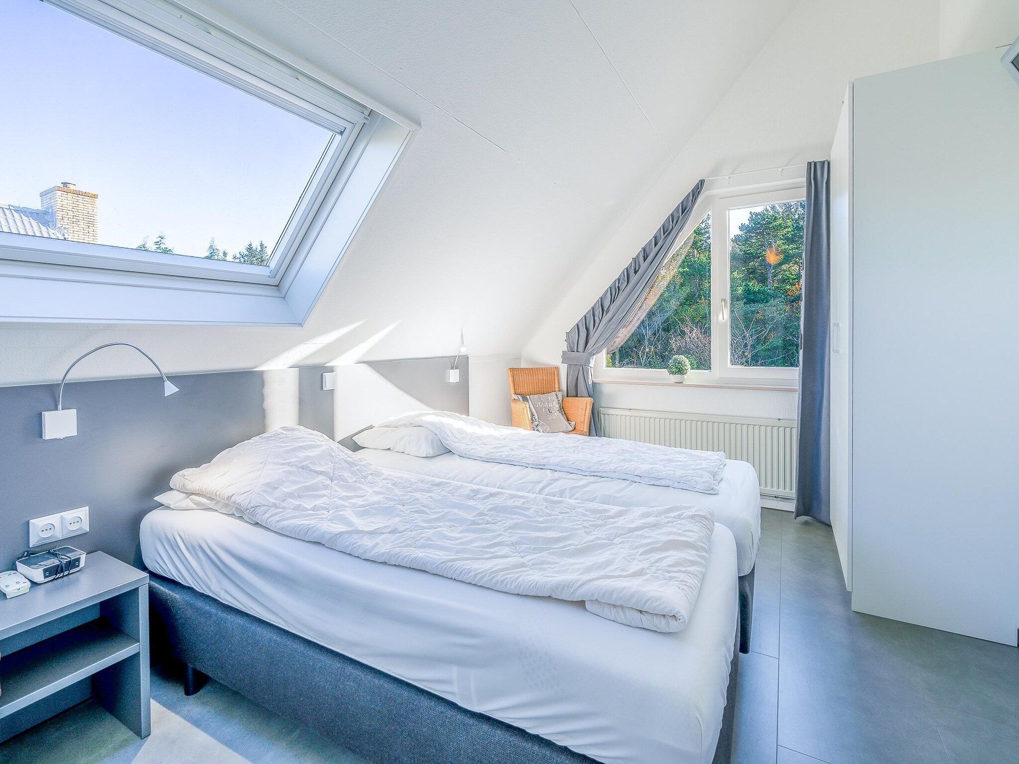 Een slaapkamer van Kamperfoelie 93 in De Koog