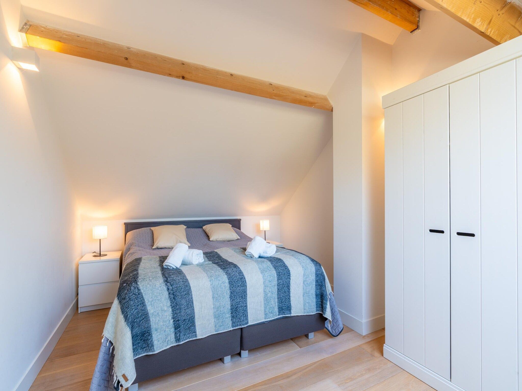 Een slaapkamer van De Wadden Parel 184 in Den Burg