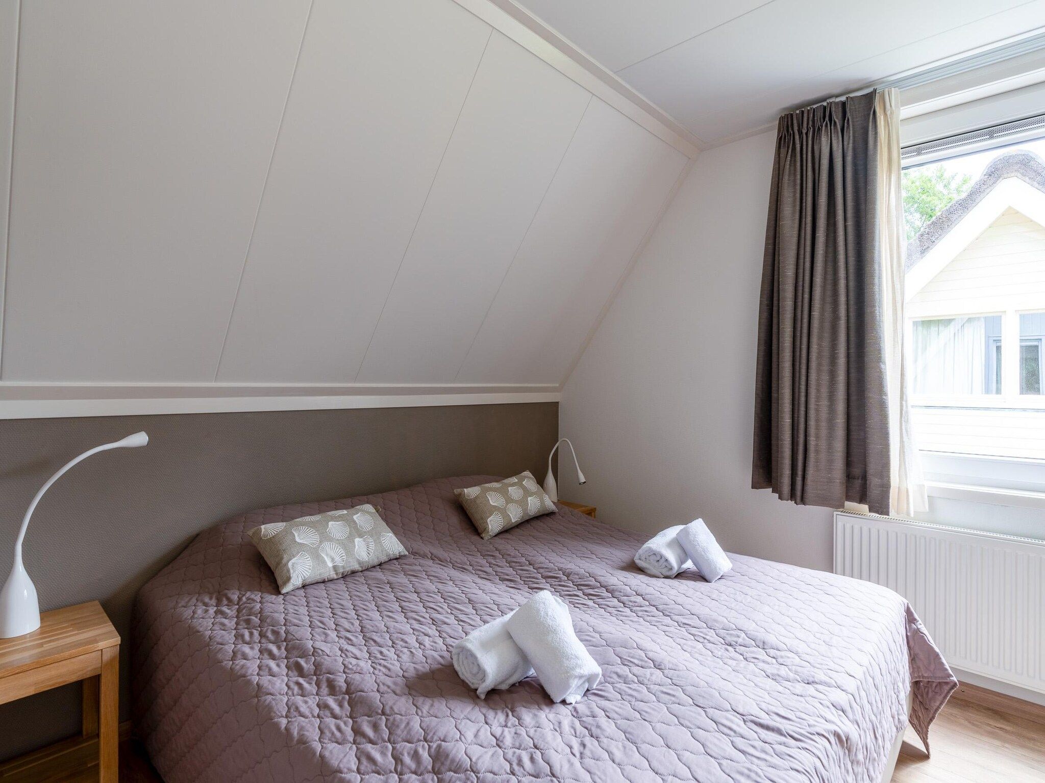 Een slaapkamer van Tempelierweg 23 in Den Burg