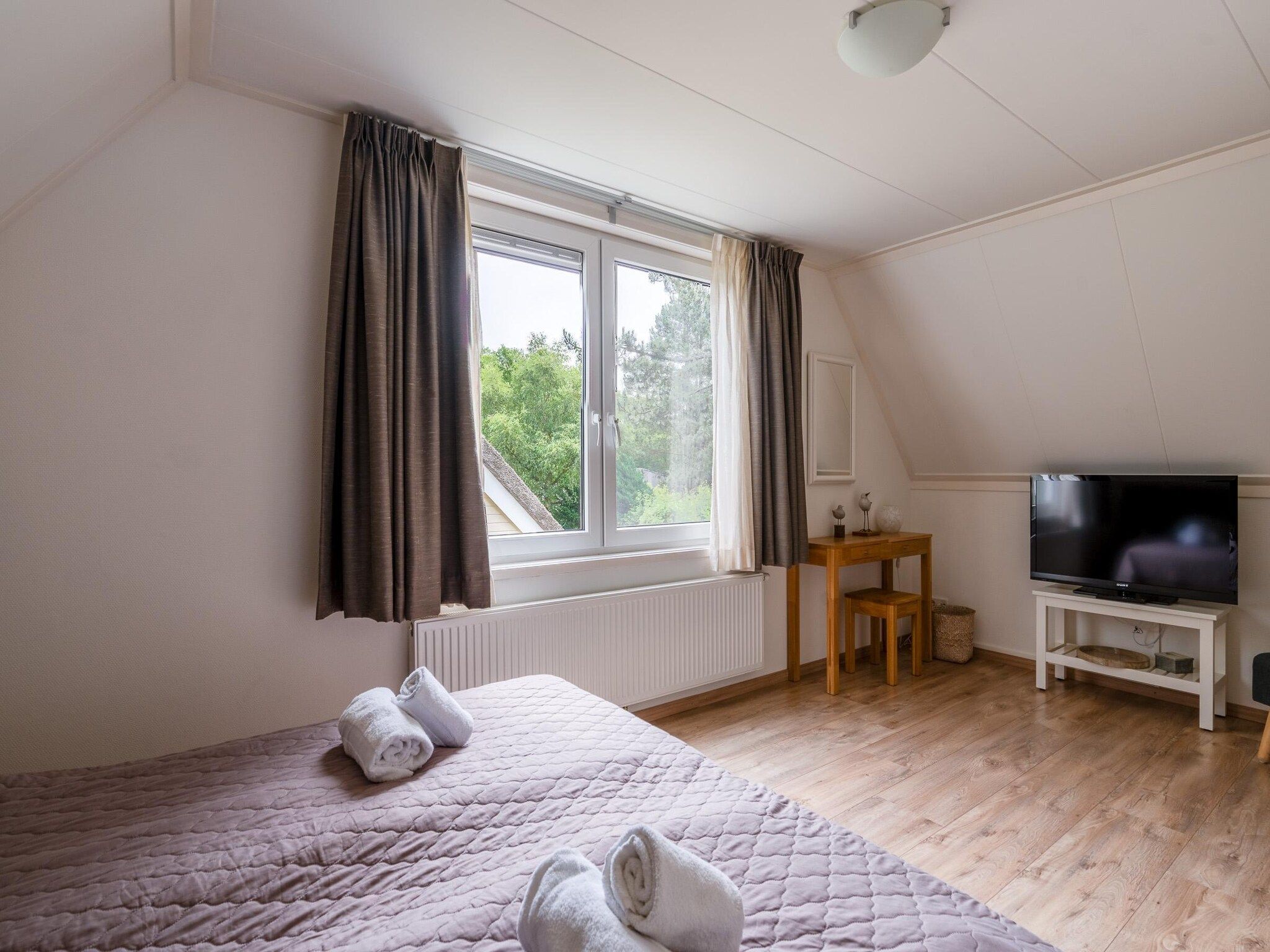Een slaapkamer van Tempelierweg 23 in Den Burg