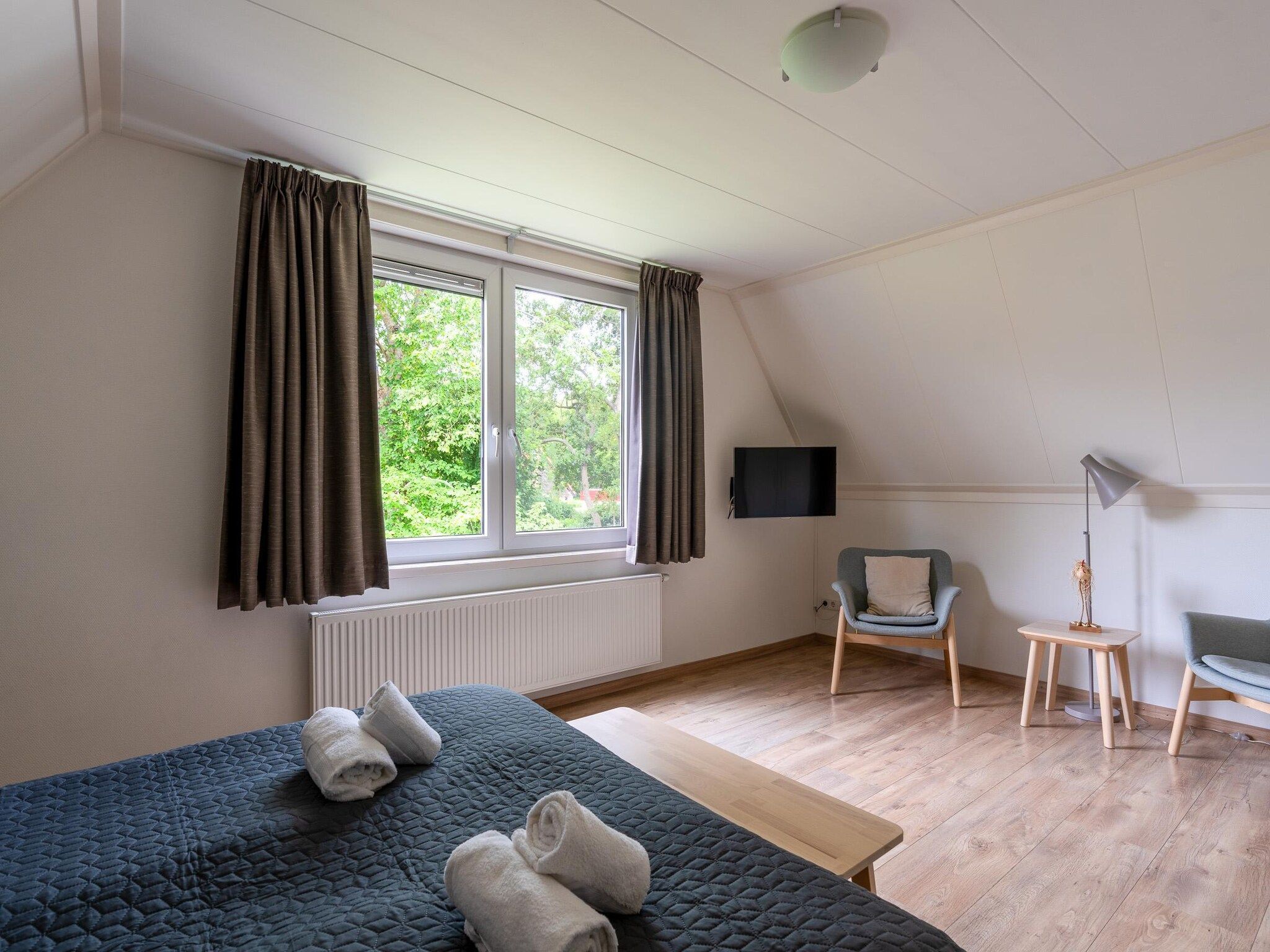 Een slaapkamer van Tempelierweg 23 in Den Burg