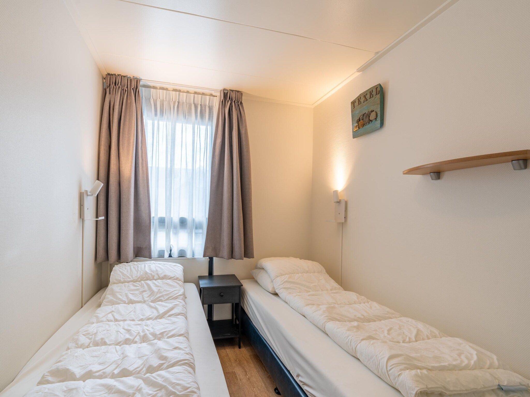 Een slaapkamer van De Anna 218 - Zee in De Koog